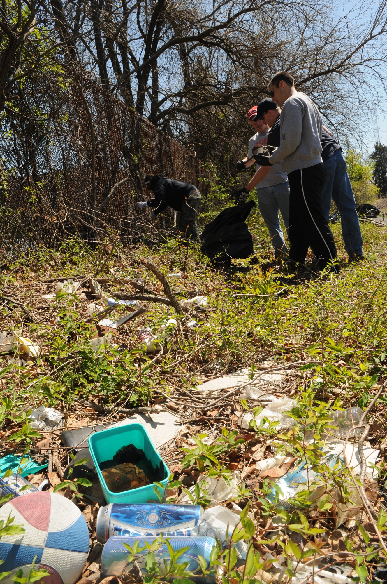 Air Force and Coast Guard members pick up trash April 17 in one of the historic cemeteries at Saint Elizabeth’s Hospital, Washington, D.C. Volunteers from Bolling, including Coast Guard members, dedicated their time to help Saint Elizabeth’s clear out overgrown brush and vines, and pick up trash in preparation to restoring their cemetery. The cemetery is the final resting place of nearly 4,000 veterans – 1,871 military veterans from the Civil War, War of 1812, Spanish-American War and World War I and 2,000 that fought a battle against mental illness. (U.S. Air Force photo by Senior Airman Marleah Miller)