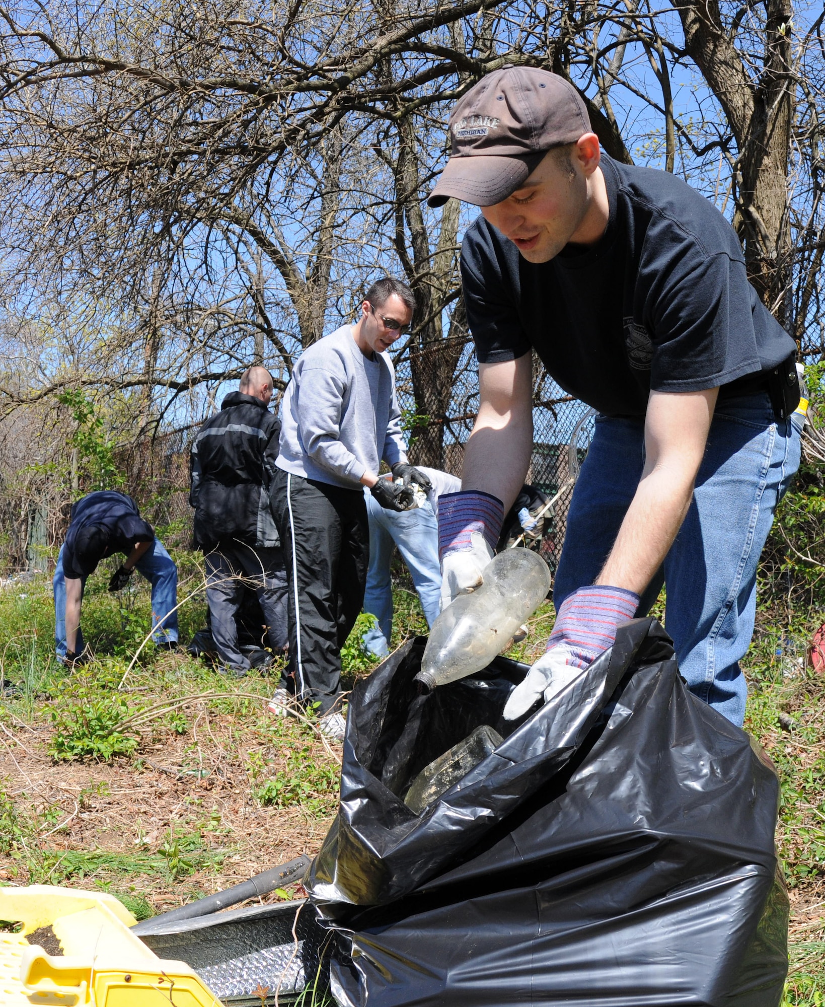 Staff Sgt. Aaron Gray, 11th Wing command chief executive assistant, collects trash April 17 in one of the historic cemeteries at Saint Elizabeth’s Hospital, Washington D.C. Volunteers from Bolling, including Coast Guard members, dedicated their time to help Saint Elizabeth’s clear out overgrown brush and vines, and pick up trash in preparation to restoring their cemetery. The cemetery is the final resting place of nearly 4,000 veterans – 1,871 military veterans from the Civil War, War of 1812, Spanish-American War and World War I and 2,000 that fought a battle against mental illness. (U.S. Air Force photo by Senior Airman Marleah Miller)