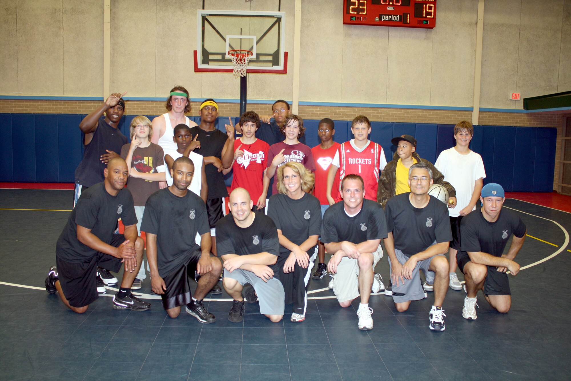 EGLIN AIR FORCE BASE -- Eglin teenagers, the victors, pose members of the 96th Security Forces Squadron after squaring off in a game of basketball. The game and other basketball contests played April 17 at the Youth Center, was part of an outreach program to engage teenagers. Investigator (Master Sgt.) Jay Curtis said, “The 96 SFS Defenders admit to losing this battle, but the war is far from being over. The rematch will be announced soon… Stay tuned for a date and time.” (U.S. Air Force photo/96th Security Forces Squadron)