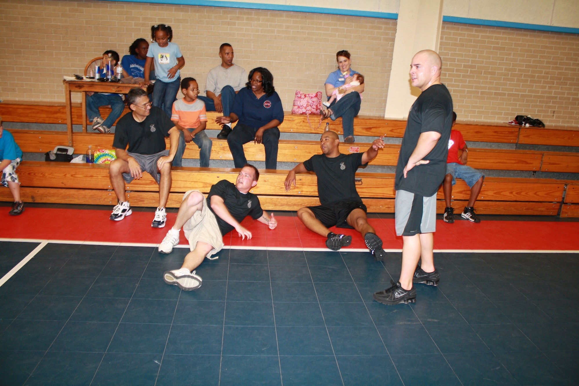 EGLIN AIR FORCE BASE -- Members of the 96th Security Forces Squadron take a breather after working free throw and three point shooting contests at the Youth Center. The 96th SFS challenged Eglin teens to a game of basketball and other basketball competitions on April 17 at the Youth Center. Several children turned out and reportedly ruled the court, but the cops vow to fight back in another match. (U.S. Air Force photo/96th Security Forces Squadron)
