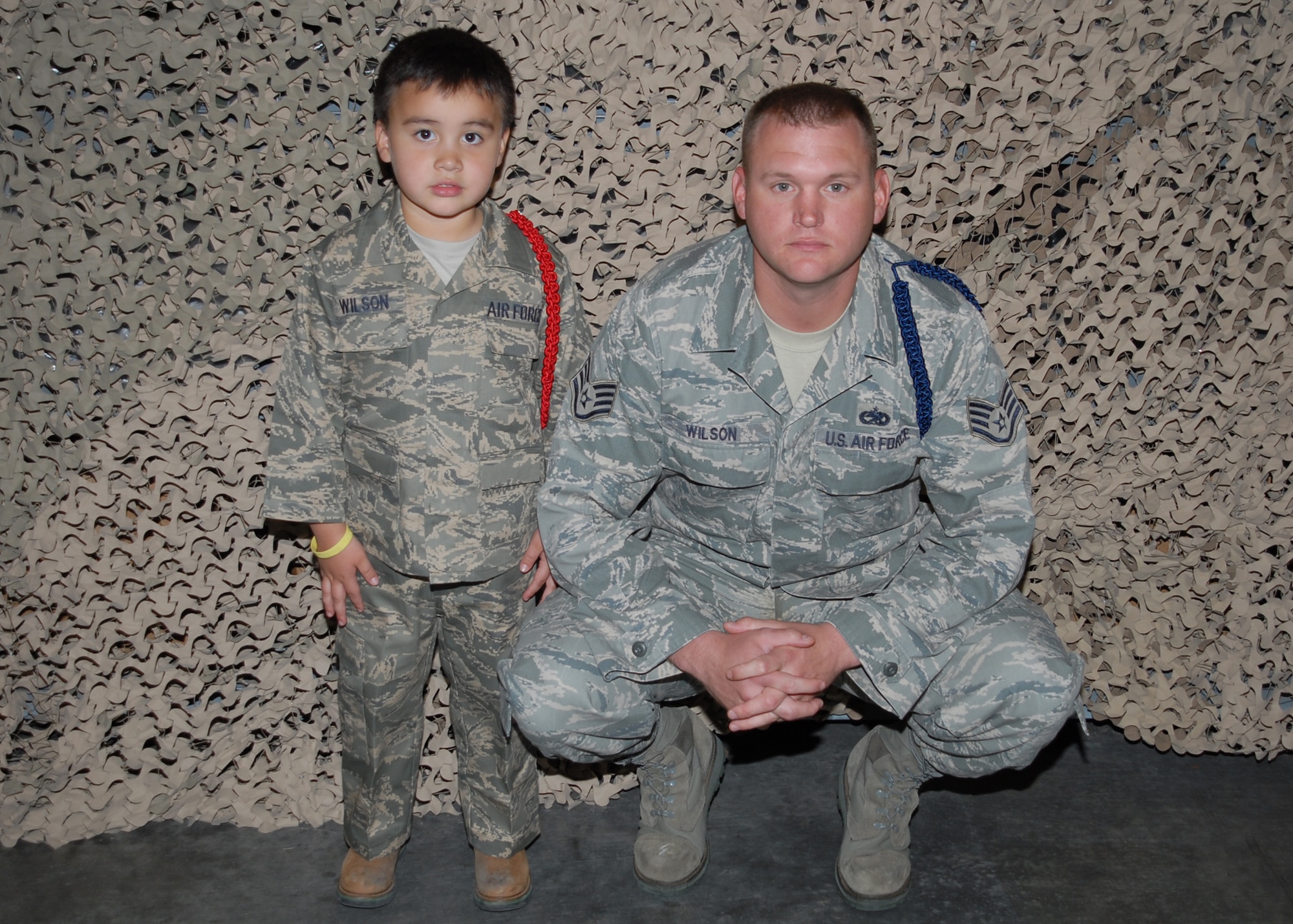 Staff Sgt. Aaron Wilson, 82nd Training Wing military training leader, and his 5-year old son Colby take a pre-deployment photo during Operation KIDS April 18 at Sheppard. Colby was one of about 100 children to participate in this event that allowed them to learn about their parents lives as Airmen. 