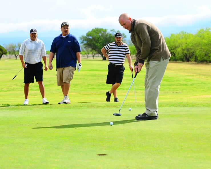 DYESS AIR FORCE BASE, Texas - Senior Airman Mike Schlauch putts on the fifth green at the Mesquite Grove Golf Course here Friday, 17 April.  The four-man scramble tournament was held to benefit the Air Force Assistance Fund. More than $500 was raised during the tournament.  (U.S. Air Force photo by Staff Sgt Alan Garrison)