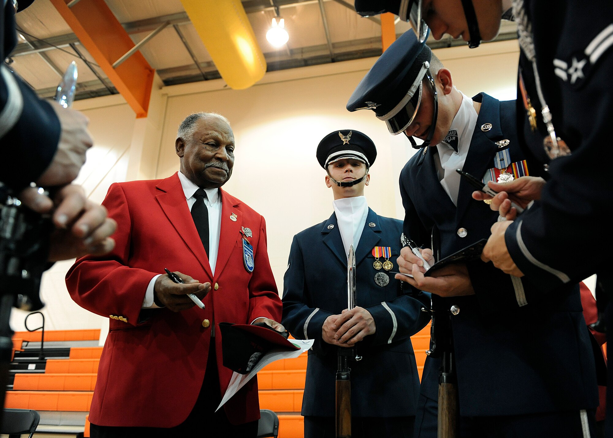 LANGLEY AIR FORCE BASE, Va. --  Air Force Honor Guard Drill Team members sign autographs for retired Chief Master Sgt. Grant Williams Sr., Tuskegee Airman, during Hampton Roads Air Force Week's Honoring America's Veterans ceremony April 20.  Air Force Week is the Air Force's chance to thank those who support the military through a variety of free events.  (U.S. Air Force photo/Senior Airman Vernon Young)