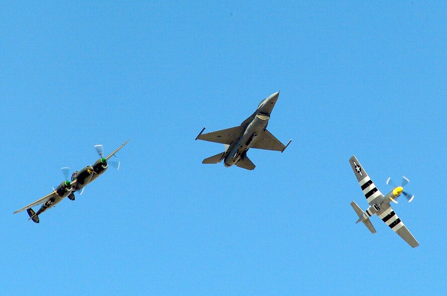 DAVIS-MONTHAN AIR FORCE BASE, Ariz. (AFPN) -- An Air Force F-16 Fighting Falcon completes a formation practice flight with a P-38J Lightning (left) and P-51 Mustang during the Heritage Flight Conference held here recently. (U.S. Air Force photo by Staff Sgt. Jeremiah Erickson)