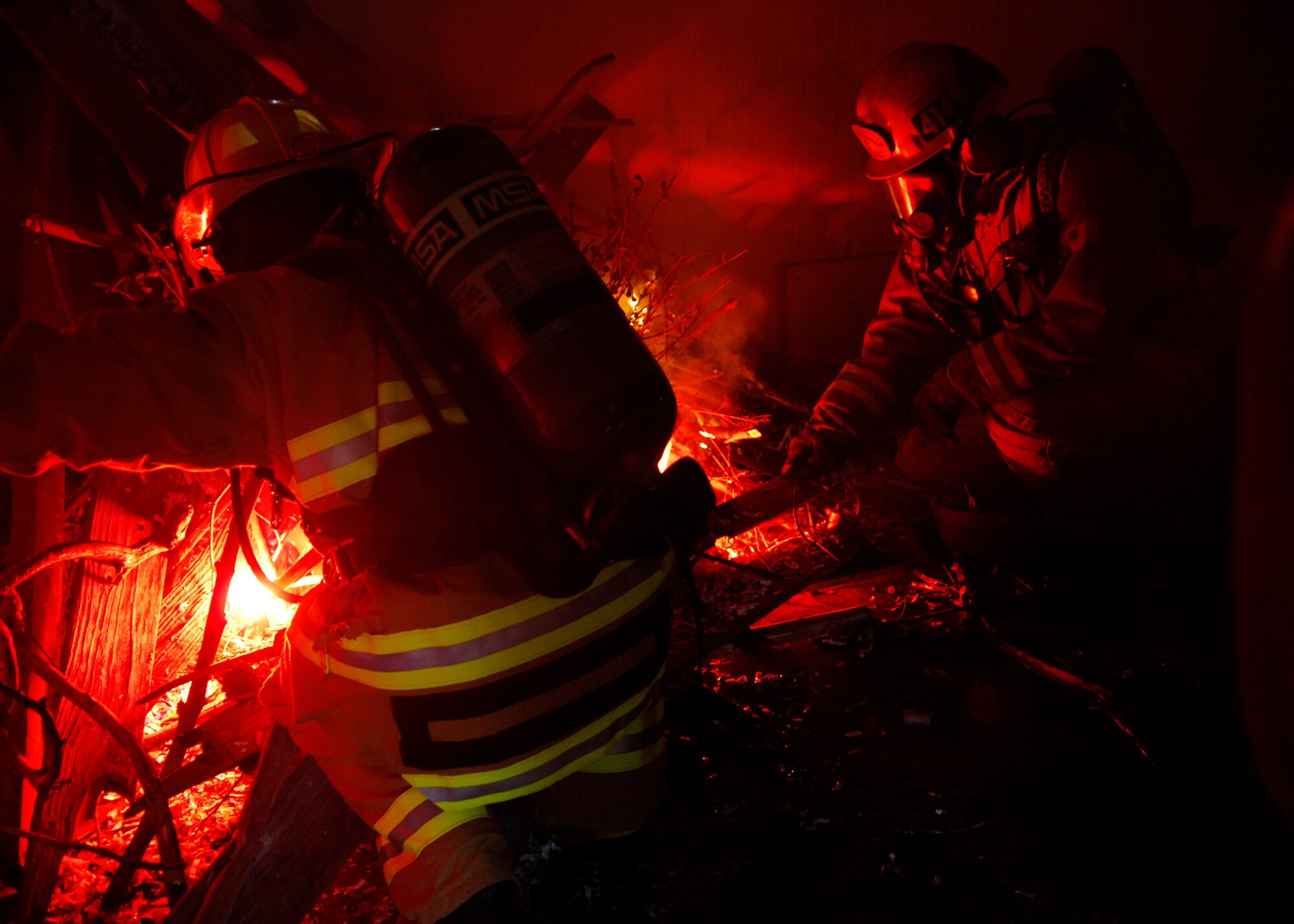 VANDENBERG AIR FORCE BASE, Calif.-- 30th Space Wing Command Chief Cari Kent ignites a house to start a fire training drill in Vandenberg's east housing April 16. The controlled burn allowed Vandenberg firefighters a chance to gain invaluable knowledge on how certain structures react to fire. (U.S. Air Force Photo/Airman 1st Class Heather Shaw)