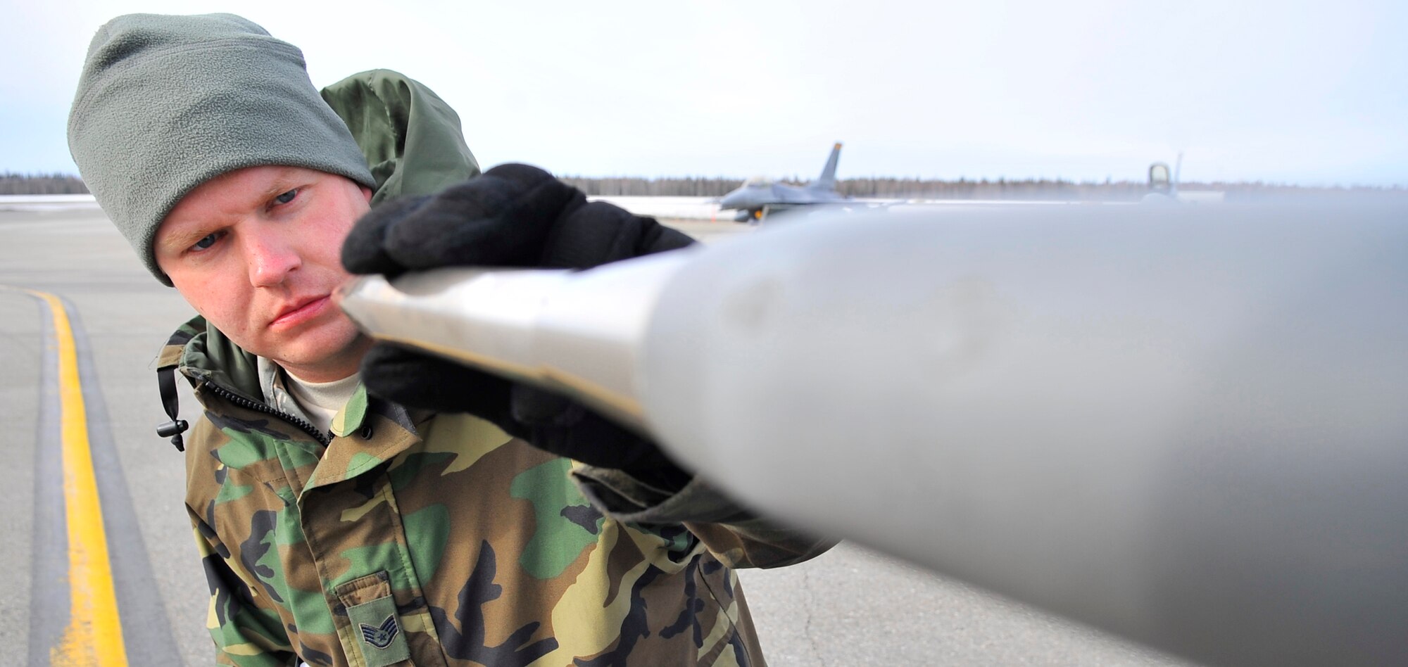 EIELSON AIR FORCE BASE, ALASKA -- Staff Sgt. James George inspects a pitot tube on an F-16 Fighting Falcon for dents and debris during RED FLAG-Alaska Apr. 17. RF-A is a Pacific Air Forces-directed field training exercise for U.S. and coalition forces flown under simulated air-combat conditions. Sergeant George is a crew chief assigned to the 132nd FW Aircraft Maintenance Squadron from Des Moines, Iowa. (U.S. Air Force photo/Senior Airman Christopher Boitz)