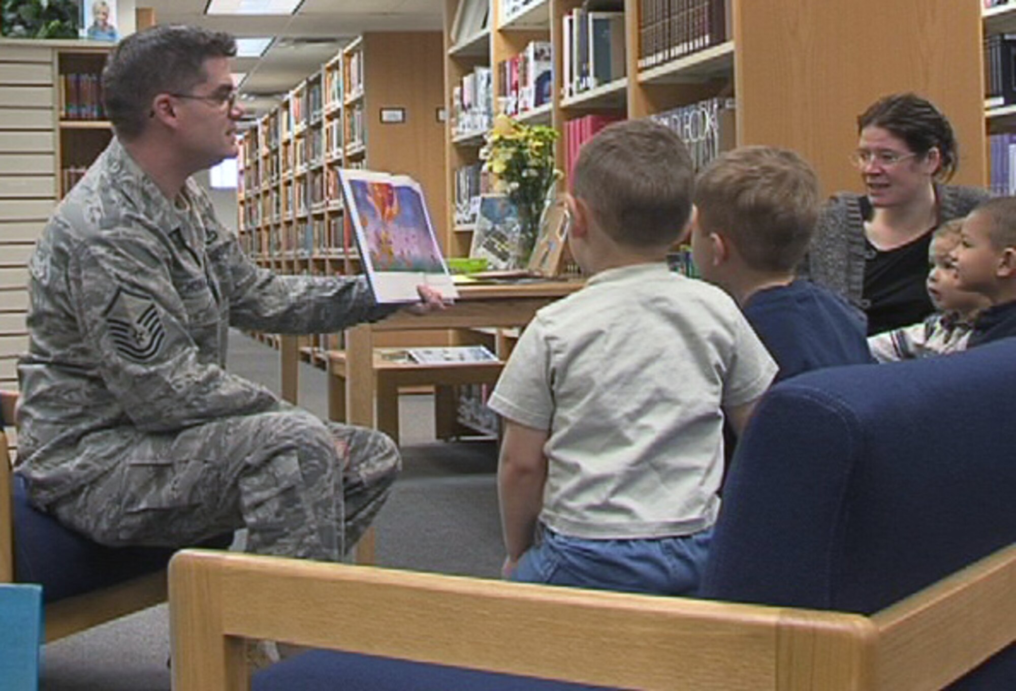 ALTUS AIR FORCE BASE, Okla. -- Master Sgt. James Howard, 97th Operations Support Squadron, reads to children during the library's weekly "story time" hour. The long-running service lets kids enjoy stories with their parents and friends and also build crafts to take home. The event highlighted National Library Week. (U.S. Air Force photo/Kenneth A. Scarle)