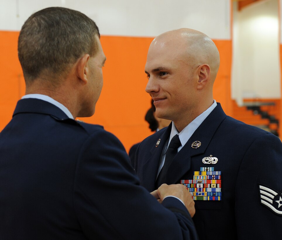 LANGELY AIR FORCE BASE, Va. -- Staff Sgt. Trent Lachance, 1st Communications Squadron, receives the Medal of Valor from Brig. Gen. Mark A. Barrett, 1st Fighter Wing commander, during Hampton Roads Air Force Week's Honoring America's Veterans ceremony April 20.  The medal is awarded to a member of the Armed Services, who distinguishes himself conspicuously by gallantry and intrepidity at the risk of his life above and beyond the call of duty.  (U.S. Air Force photo/Airman 1st Class Zachary Wolf)