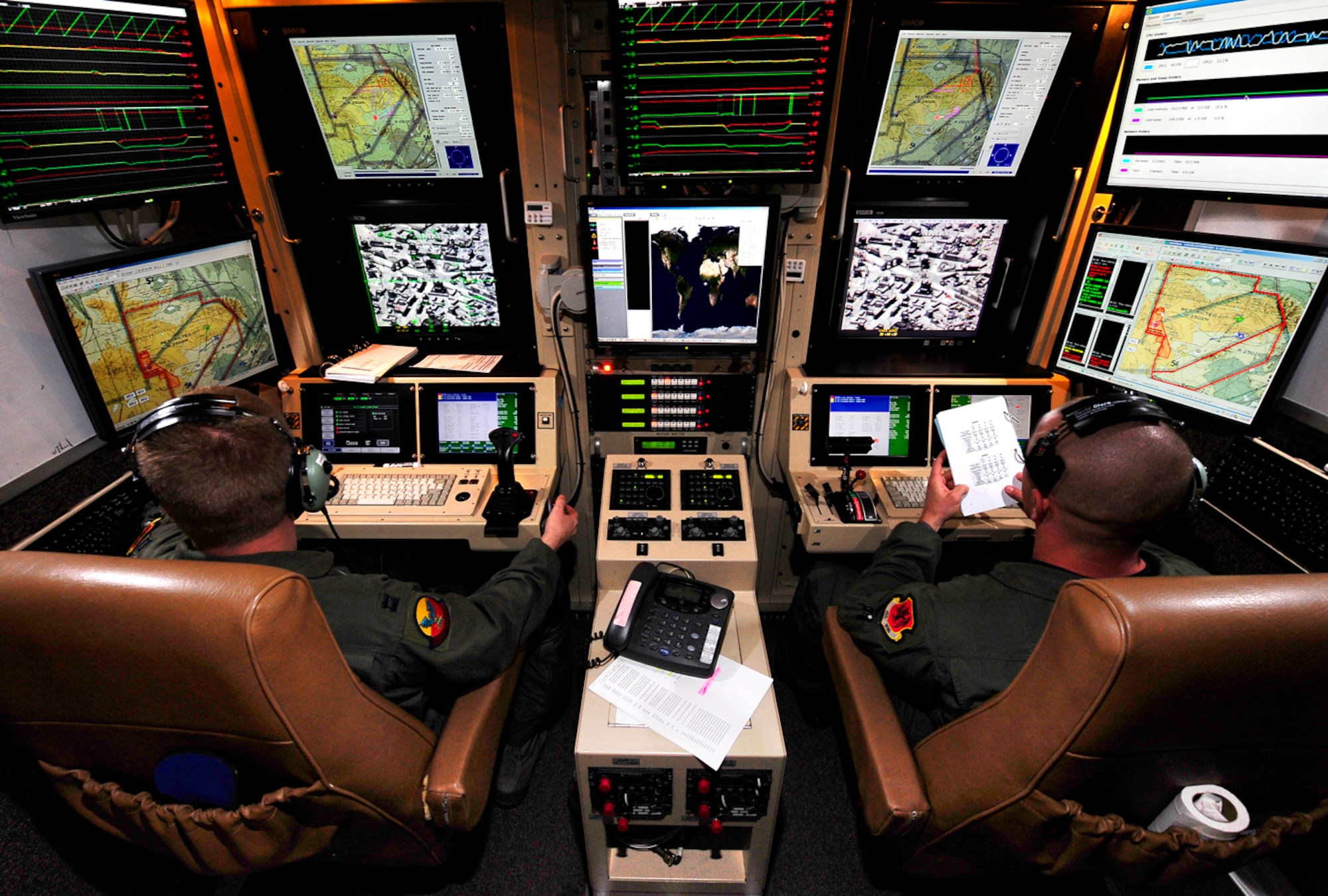 Capt. Joshua Andrews (left), a student pilot and Tech. Sgt. Brandon Homer (right), a student sensor operator, fly an Unmanned Arial System over a training range on April 9 at Holloman Air Force Base, N.M. Captain Andrews and Sergeant Homer are members of the 29th Attack Squadron and are recording attack runs to construct an abbreviated checklist for future UAS classes. (U.S. Air Force Photo/Tech. Sgt Christopher Flahive)