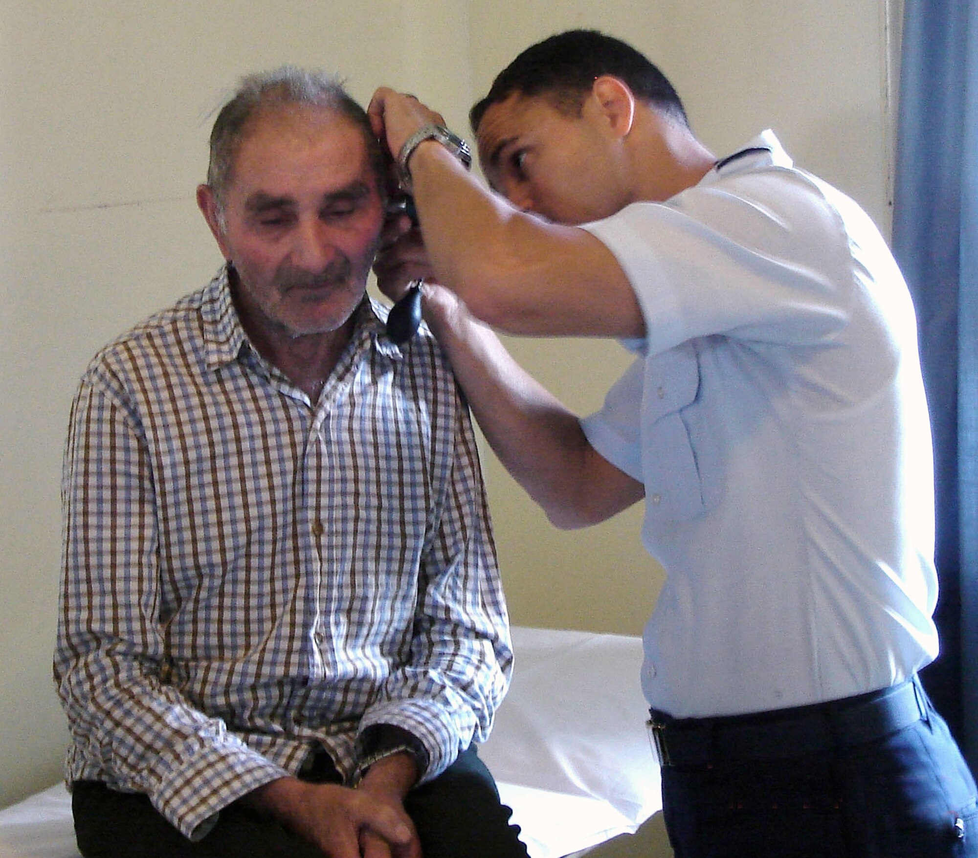 Maj. (Dr.) Jose Barrera, an ear, nose and throat physician, examines a patient in the otolaryngology clinic at the Chile Chico hospital in the Patagonia region of Chile March 24. Major Barrera was part of a team of 11 Air Force medics from the 59th Medical Wing who participated in a medical readiness training exercise with 31 Chilean air force medics. (U.S. Air Force photo)
