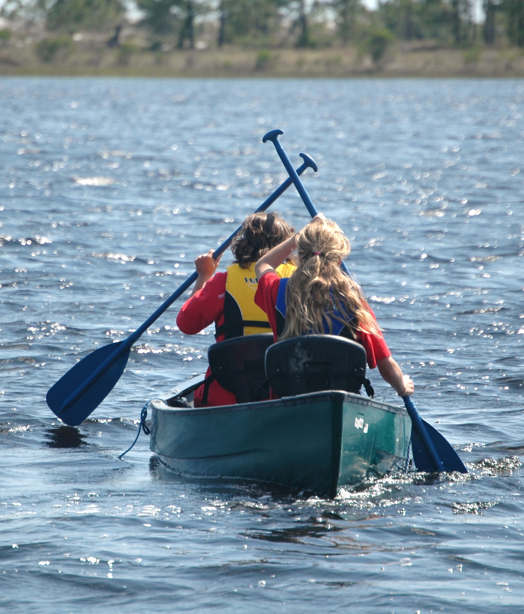 Julee McIntosh and her daughter Carolyn, family members of Staff Sgt. James McIntosh, 325th Fighter Wing command post technician, take a canoe ride into the bay during the 325th Force Support Squadron's "Spring Fling" event April 17 at Heritage Park. The duo were able to take the canoe out free-of-charge at the event thanks to 325 FSS Outdoor Recreation, saving them the usual cost of $9 for a half-day rental. (U.S. Air Force photo/Staff Sgt. Joshua Stevens)