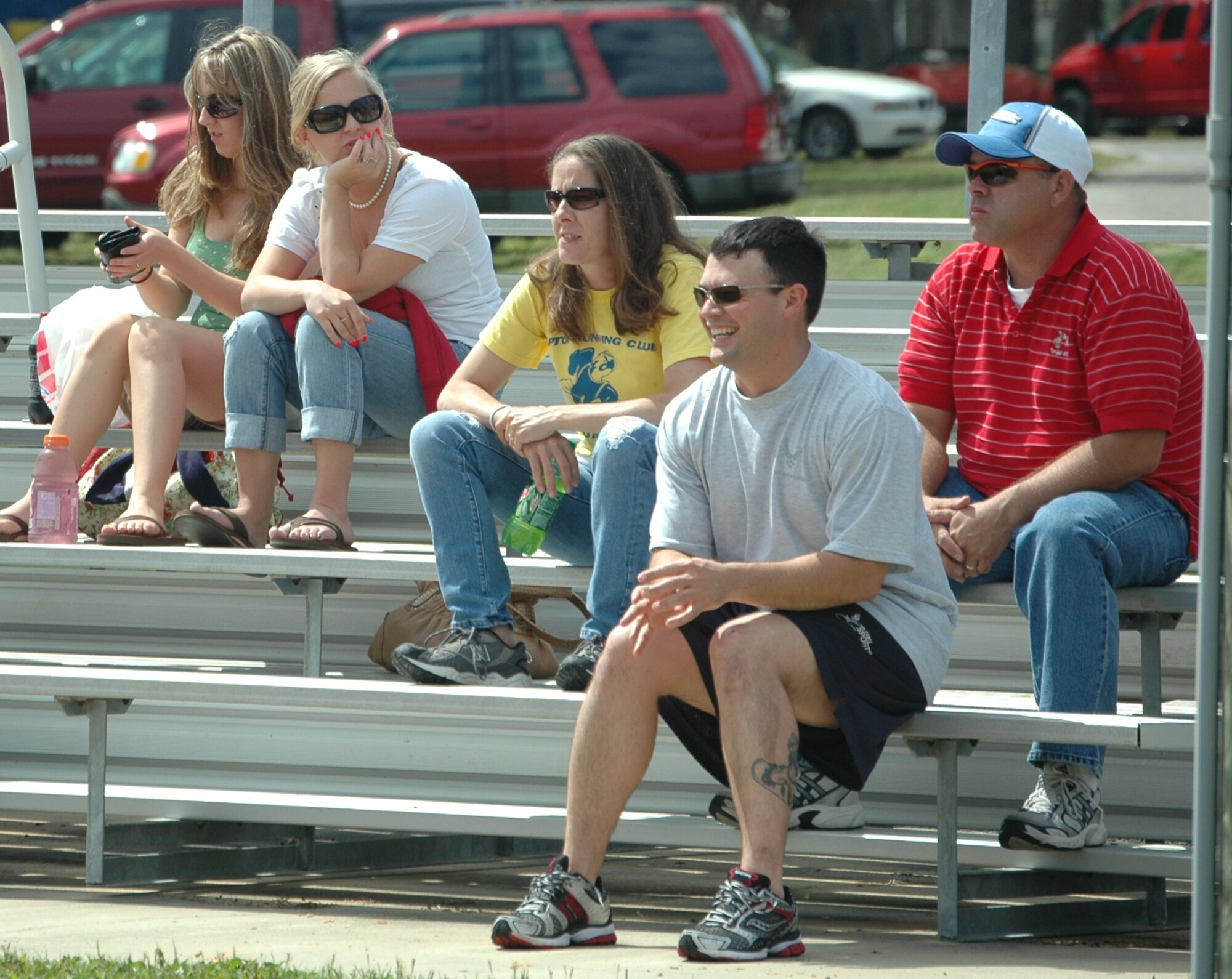 Tyndall community members enjoy the sun and spectate during a 1-pitch, 6-inning softball game between junior enlisted members and company grade officers at the 325th Force Support Squadron's "Spring Fling" event April 17. Over the course of the afternoon game, the spectators eventually saw the CGOs fall to the enlisted members, losing the game with a score of 6 to the enlisted members' 8. (U.S. Air Force photo/Staff Sgt. Joshua Stevens)