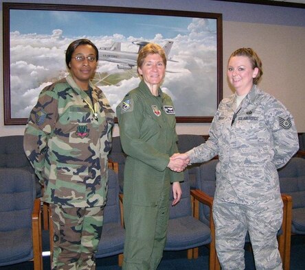 552nd Air Control Wing Commander Col. Pat Hoffman congratulates Tech. Sgt. Ashley Kimbrough on her certification as an Emergency Actions Controller for the 
552 ACW Command Post. Master Sgt. Rachel Polite (left) happily welcomes Sgt. Kimbrough to the 552 ACW Command Post team. 