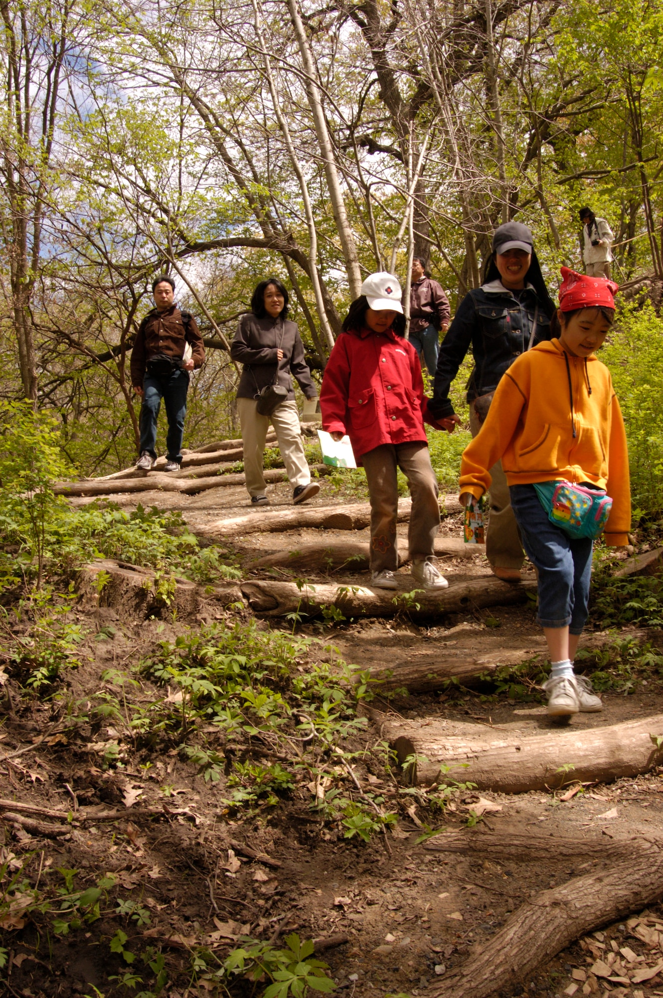 NEBRASKA CITY, Neb. -- A family hikes on the Exploratory Trail at
Arbor Day Farms in Nebraska City. With apple blossoms in full bloom,
officials at the farm said April 25 and 26 will be the perfect time for a
visit. Photo courtesy of Arbor Day Farms
