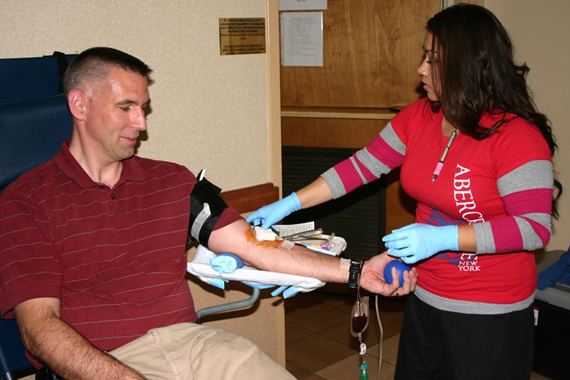 Phlebotomist Roxie Torres draws blood from Bob Landis, Air Force Personnel Center directorate of civilian force integration communications, during a blood drive April 17 at AFPC, Randolph Air Force Base, Texas. AFPC members gave more than 40 pints of blood that will be used to supply life-saving blood products to warfighters in Operation Iraqi Freedom and Operation Enduring Freedom. Ms. Torres is from the Blood Donor Center at nearby Lackland AFB, Texas  (Air Force photo/Staff Sgt. Steve Grever)