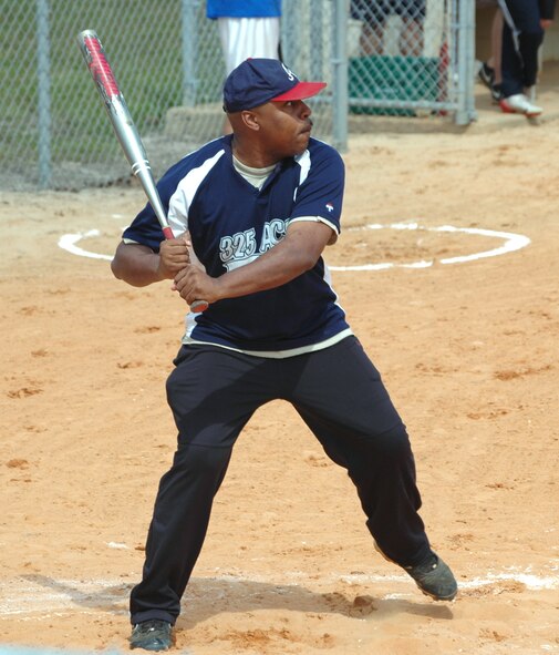 Staff Sgt. Mark Ford, 325th Air Control Squadron International Training Flight NCO in charge, begins his swing during the 1-pitch, 6-inning softball game between junior enlisted members and company grade officers at the 325th Force Support Squadron's "Spring Fling" event April 17. The enlisted members claimed victory over the CGOs with a final score of 8 to 6. (U.S. Air Force photo/Staff Sgt. Joshua Stevens)
