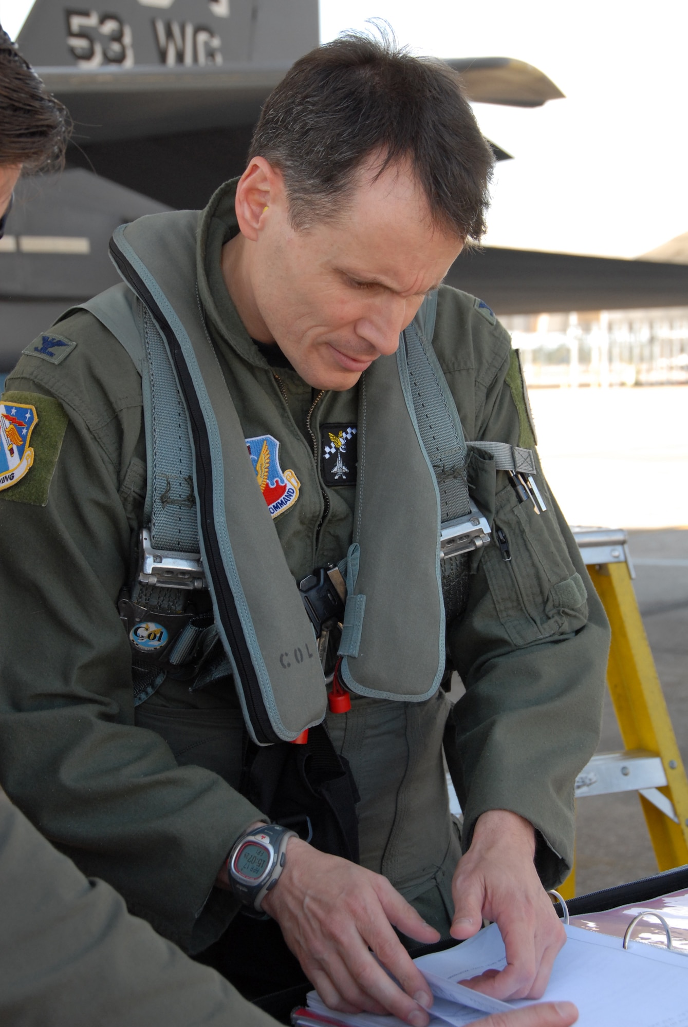 Colonel Steve DePalmer, 53d Wing commander, reviews the flight book before taking his final flight in the wing’s aircraft April 17 at Eglin Air Force Base.  Colonel DePalmer leaves the 53d Wing in May, after only a year, to become the vice commander of 14th Air Force.  Photo by Samuel King Jr.