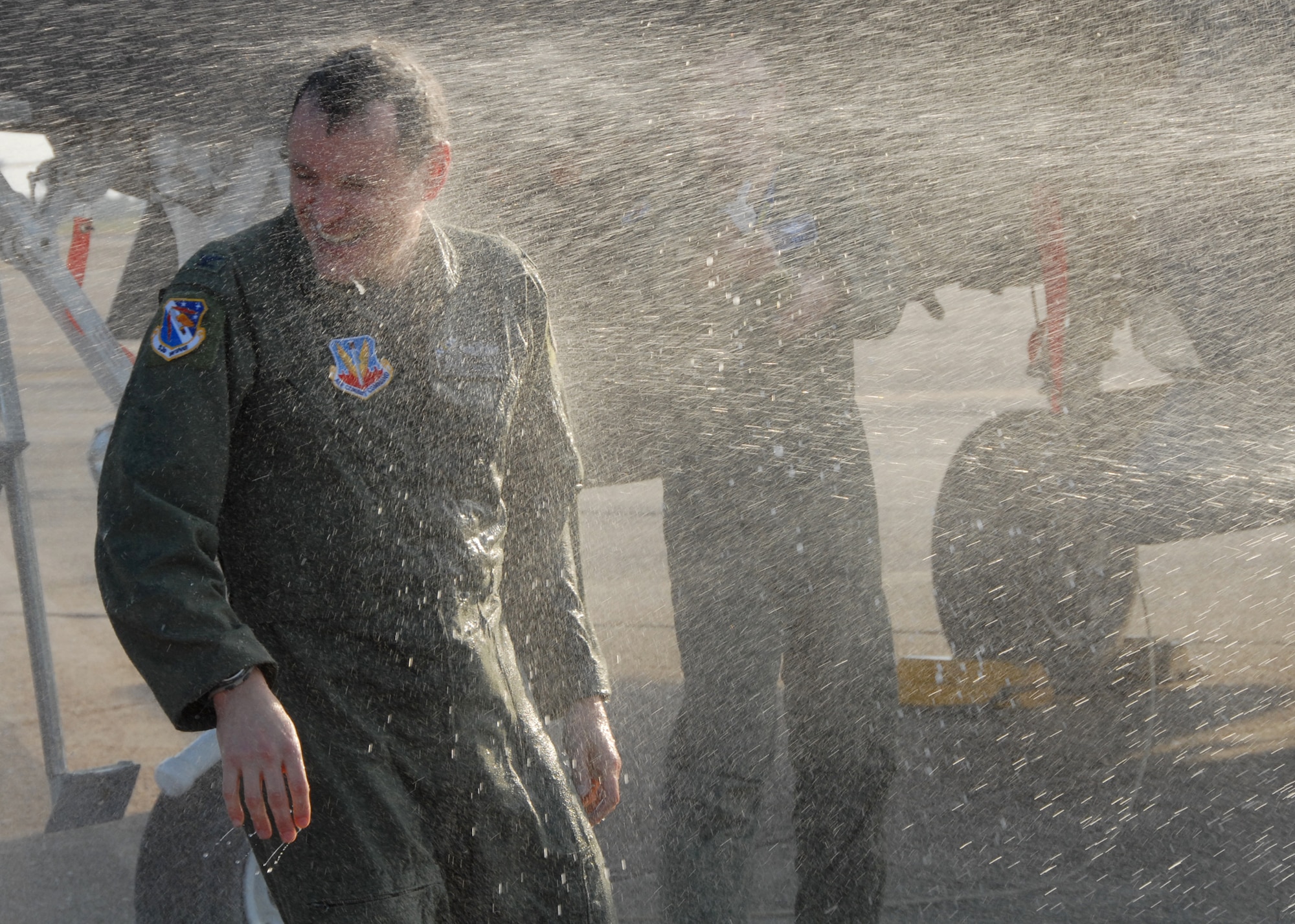 Colonel Steve DePalmer, 53d Wing commander, gets hosed down by friends and family after his final flight with the wing April 17 at Eglin base operations.  Colonel DePalmer leaves the 53d Wing in May, after only a year, to become the vice commander of 14th Air Force.  Photo by Samuel King Jr.