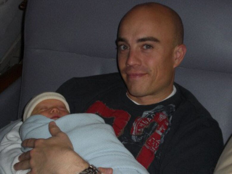 Staff Sgt. Paul Lindsay, 66th Comptroller Squadron budget analyst, holds his newborn son, Aidan. Aidan, who was due on Feb. 25, was born March 5, in Rochester, N.Y., less than 48 hours after Sergeant Lindsay returned to Hanscom from an eight month deployment in Iraq.  (Courtesy photo)