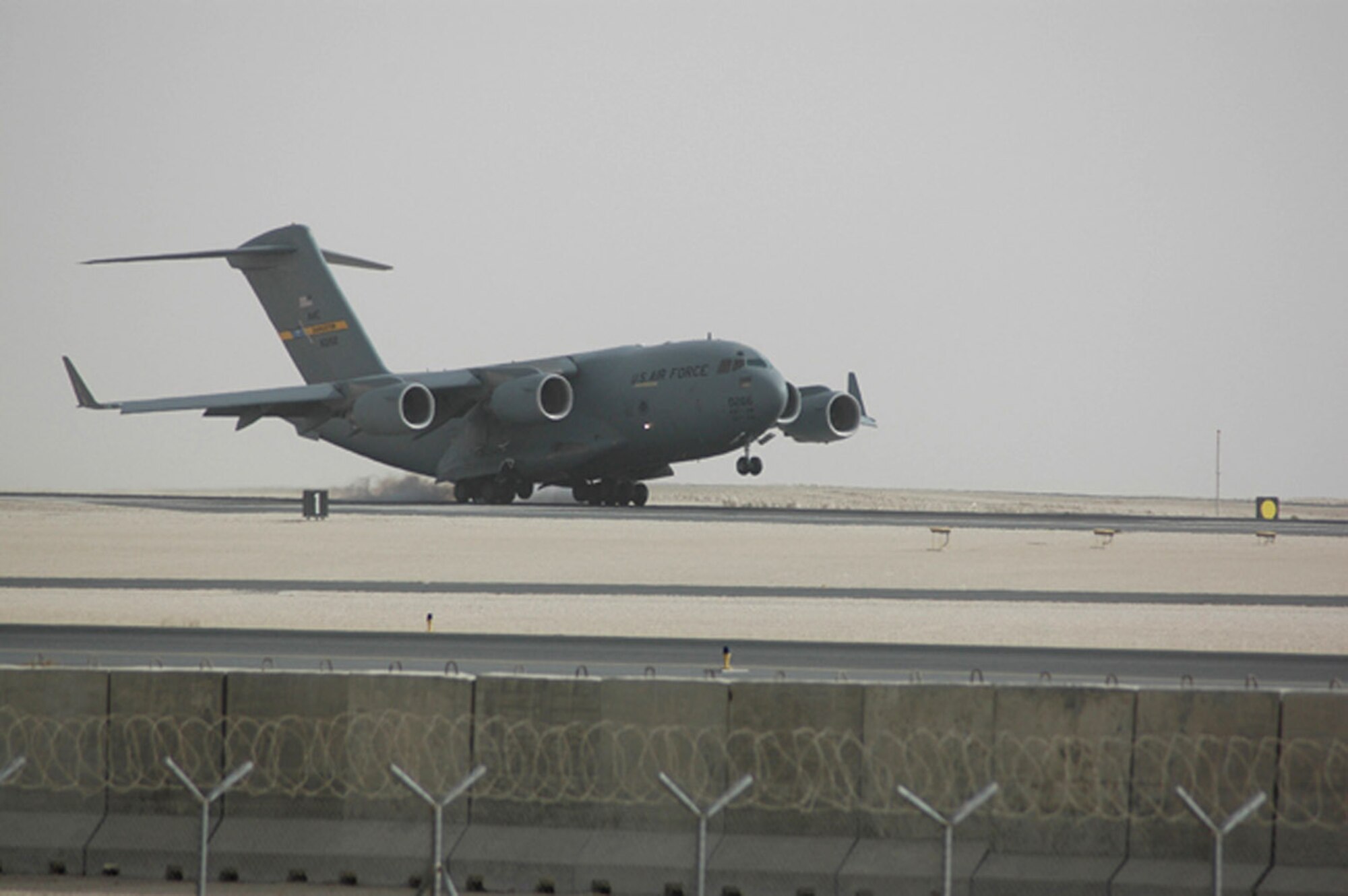 A C-17 Globemaster III touches down at an air base in Southwest Asia upon returning from a mission. The C-17 performs tactical airlift and airdrop missions, transports passengers, delivers troop resupply and all types of cargo throughout Southwest Asia in support of operations Enduring Freedom and Iraqi Freedom.  (U.S. Air Force photo/Senior Airman Clark Staehle)