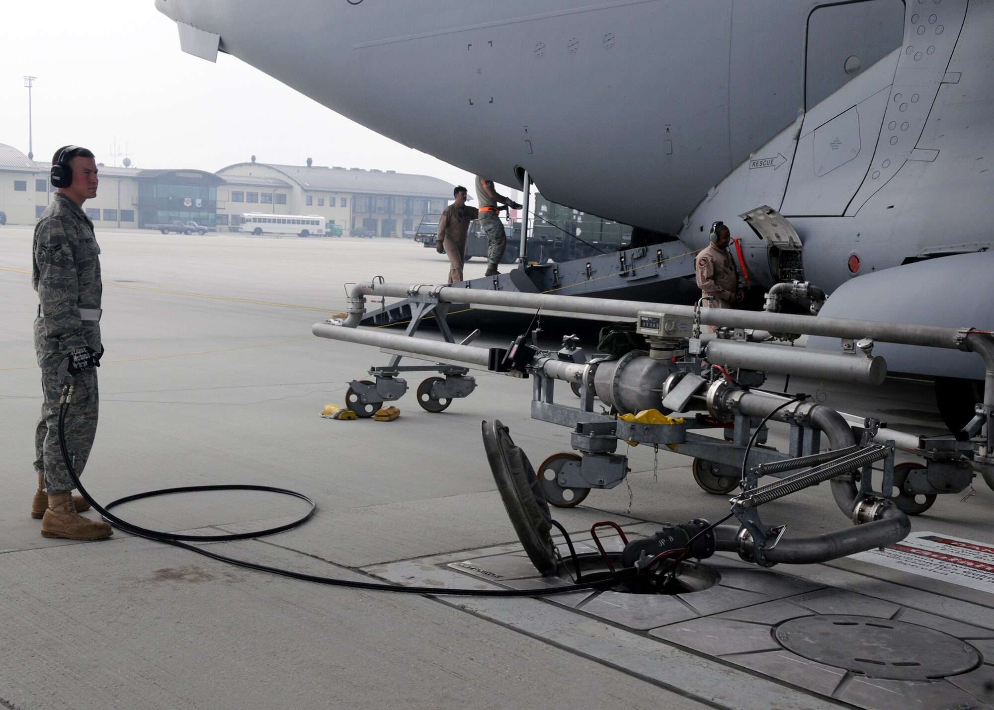 SPANGDAHLEM AIR BASE, Germany – Airman 1st Class Adam Kessler, 52nd Logistics Readiness Squadron, assists in refueling a C-17 Globemaster, April 10, 2009. The 726th Air Mobility Squadron recently conducted an Air Force Smart Operations for the 21st Century value stream analysis looking for ways to streamline C-17 refueling and increase proficiency levels.  The team came up with 84 suggested technical order improvements, which they will submit through Air Force TO improvement channels. (U.S. Air Force photo by Airman 1st Class Staci Miller)