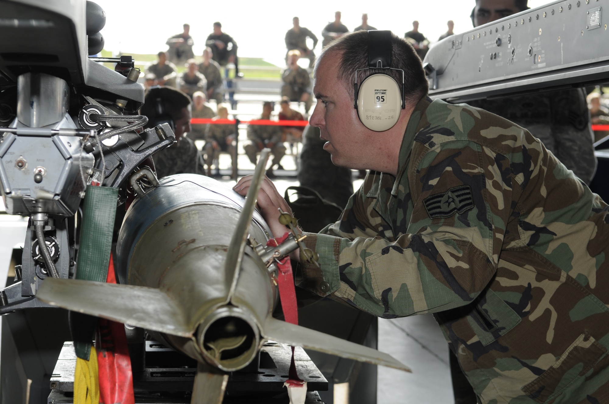 SPANGDAHLEM AIR BASE, Germany – Staff Sgt. Jason Edgington, 52nd Aircraft Maintenance Squadron, loads a simulated munition during a quarterly load crew competition April 10, 2009.  Sergeant Edgington and his crew were the first in the competition to finish loading their munitions.  (U.S. Air Force photo by Senior Airman Allen Pollard)