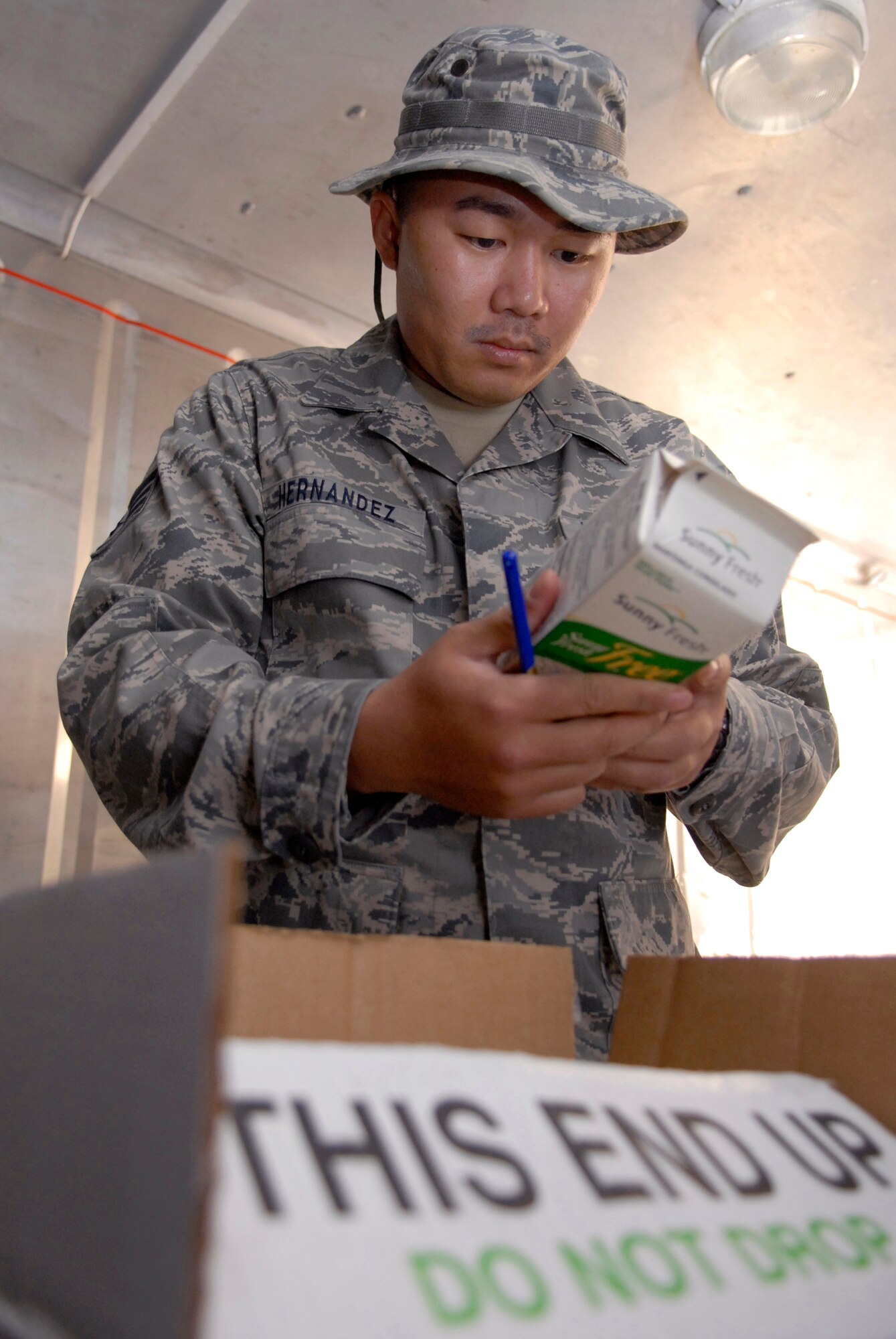 Staff Sgt. Rommel Hernandez, a 379th Expeditionary Medical Group public health inspector, checks the expiration date on a container of egg beaters, during the monthly dining facility inspection, Apr. 18, 2009, at an undisclosed location in Southwest Asia.  The Public Health office inspects the dining facilities, checks personnel medical records, and provides medical intelligence for forward deployers.  Sergeant Hernandez hails from Arlington, Va. and is deployed from Keesler Air Force Base, Miss. in support of Operations Iraqi and Enduring Freedom and Combined Joint Task Force - Horn of Africa.  (U.S. Air Force photo/Senior Airman Andrew Satran/released)  
