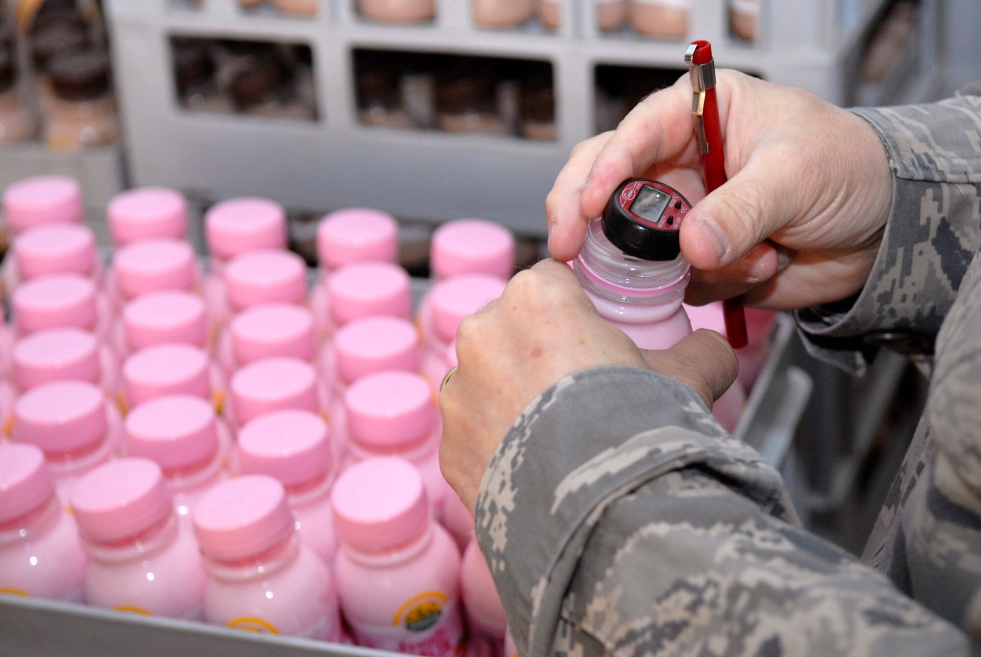 Tech. Sgt. Duwayne Foster, 379th Expeditionary Medical Group NCO in charge of public health, takes the temperature of a bottle of milk to ensure it is properly refrigerated during the monthly dining facility inspection, Apr. 18, 2009, at an undisclosed location in Southwest Asia.  The Public Health office inspects the dining facilities, checks personnel medical records, and provides medical intelligence for forward deployers.  Sergeant Foster hails from Mobile, Ala. and is deployed from Keesler Air Force Base, Miss. in support of Operations Iraqi and Enduring Freedom and Combined Joint Task Force - Horn of Africa.  (U.S. Air Force photo/Senior Airman Andrew Satran/released)