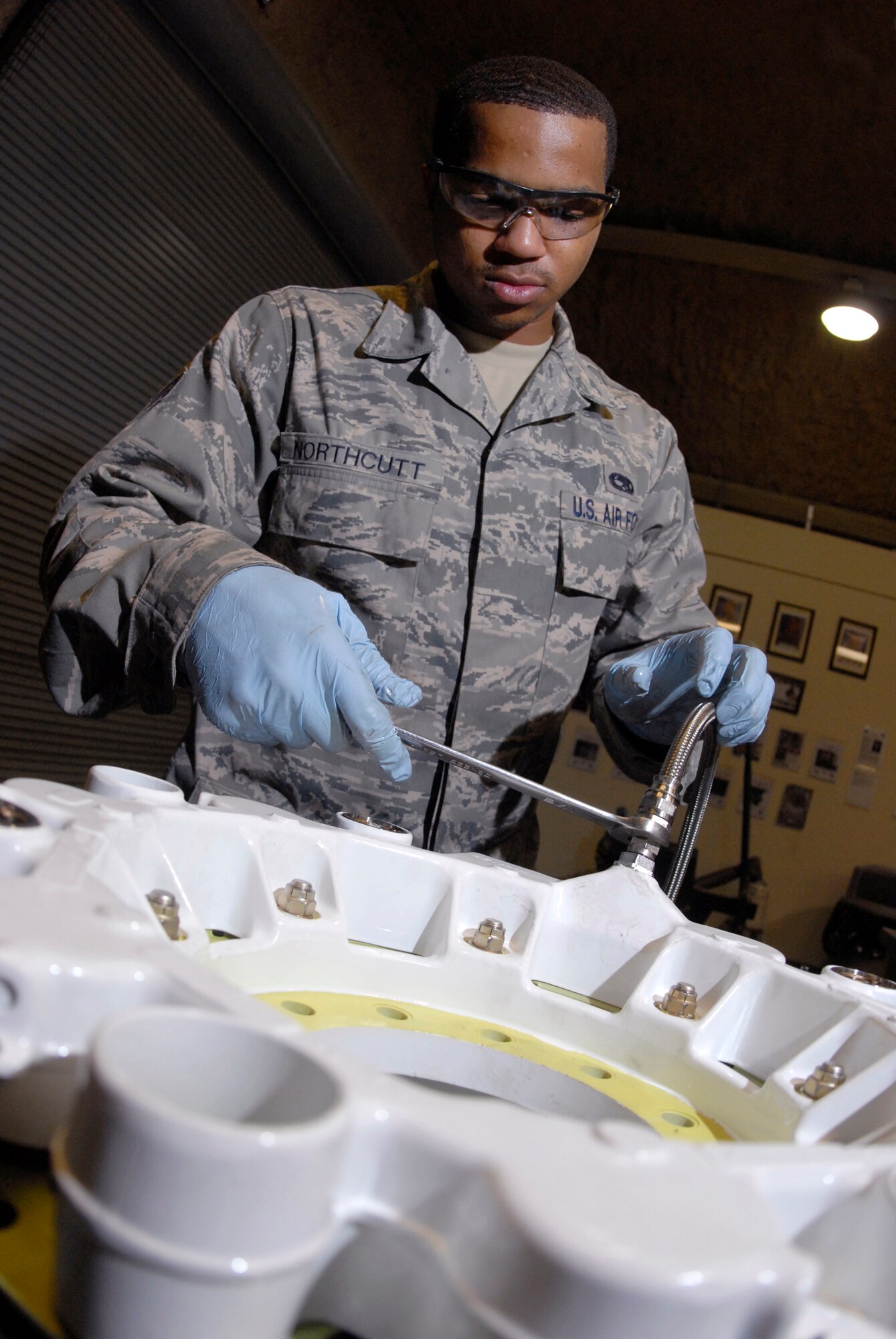 Senior Airman Joseph Northcutt, a 379th Expeditionary Maintenance Squadron hydraulics journeyman, attaches a hydraulic test hose to check the KC-135 Stratotanker steel brake unit for leaks after assembly, Apr. 17, 2009, at an undisclosed location in Southwest Asia.  The base hydraulic shop supports all of the C-135 airframes in the U.S. Central Command's Area of Responsibility.  Airman Northcutt hails from Los Angeles, Calif. and is deployed from Fairchild Air Force Base, Wash. in support of Operations Iraqi and Enduring Freedom and Combined Joint Task Force - Horn of Africa.  (U.S. Air Force photo/Senior Airman Andrew Satran/released)