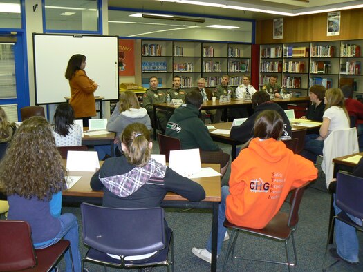 Kareen Borders, standing, NASA Explorer School team lead at Key Peninsula Middle School in Lakebay, Wash., introduces pilots from McChord’s airlift squadrons and civilian pilots during a pilot panel March 23. McChord annually sends pilots to speak on the panel, giving students a chance to ask questions ranging from “what is your favorite aircraft to fly?” to “what are your words of advice on achieving your goals?”. This year’s pilots from Team McChord were Captains Daniel Arneson and Brian Yeargan, 10th AS; and Maj. Kevin Cummings, 8th AS. (U.S. Air Force photo/Staff Sgt. Eric Burks)