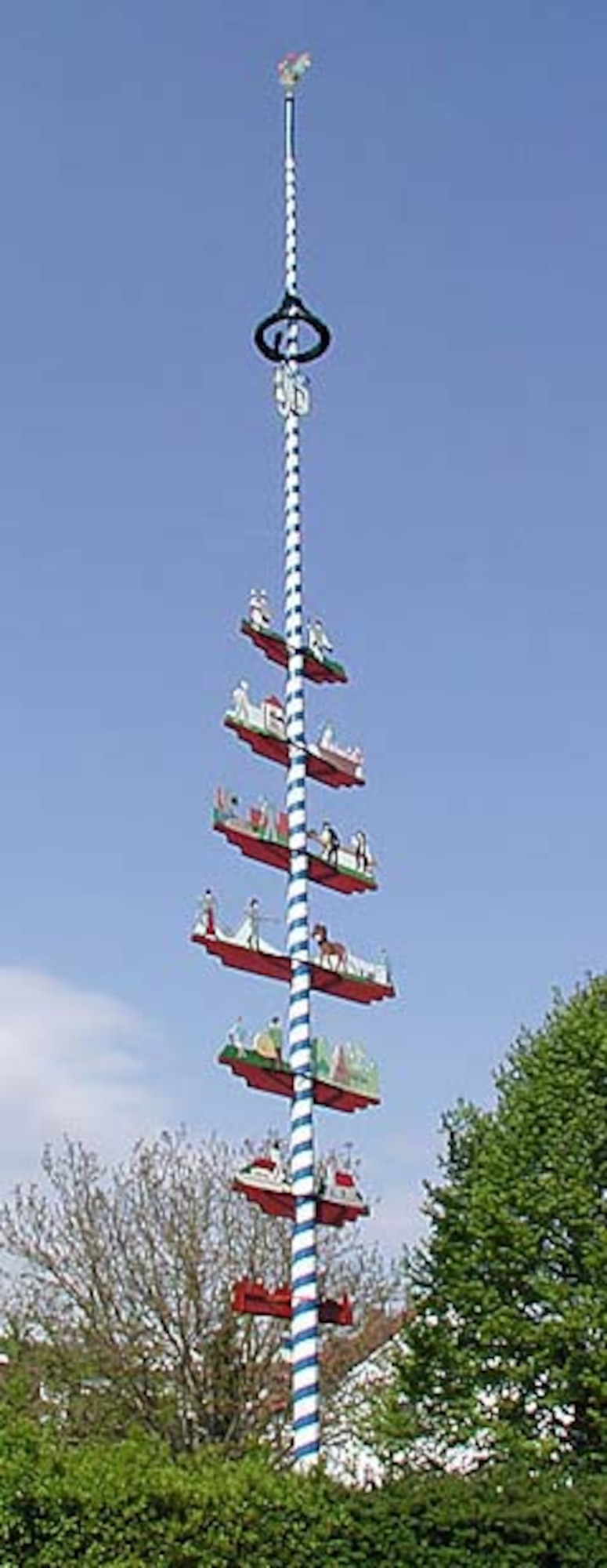 MARKTL, Bavaria -- This blue and white striped May pole in Marktl, Bavaria is a typical example of a Bavarian May tree. A May pole is a wooden pole made from a tree trunk of pine or birch, typically decorated with colorful ribbons, flowers, carved figures and various other decorations, depending on regional tradition. (Courtesy photo)