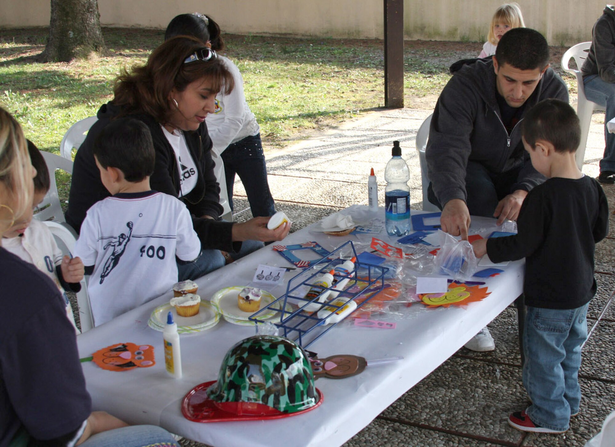 Senior Airman Benjamin Weintraub and his son Nathan Weintraub work on a craft project after the Area 1 Child Development Center's Annual Month of the Military Child Parade earlier this month. The Department of Defense observance, now in its 23rd year, reflects on the important role military children play in the Armed Forces community. (U.S. Air Force photo/Rebecca White)