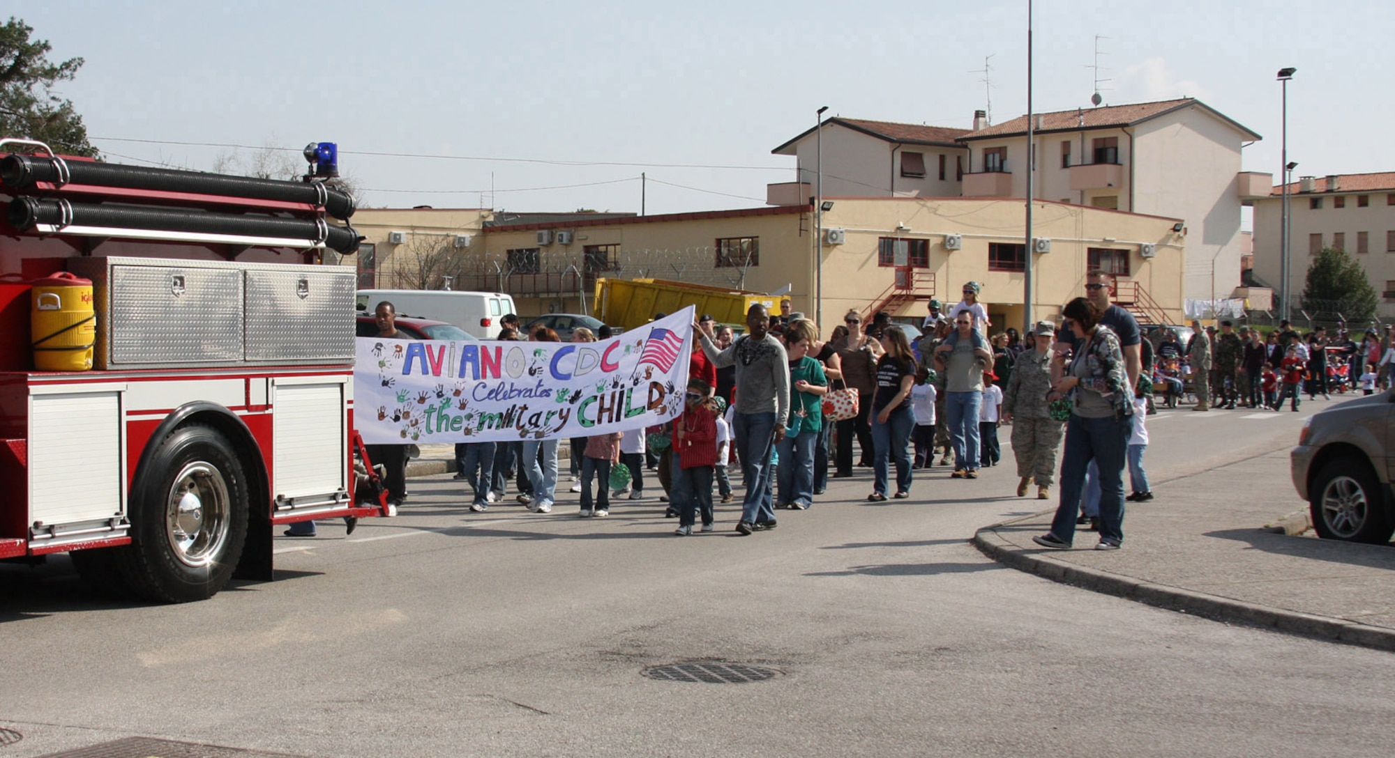 A fire truck leads a procession of Area 1 Child Development Center students, teachers and parents during the CDC's Annual Month of the Military Child Parade earliler this month. The Department of Defense observance, now in its 23rd year, reflects on the important role military children play in the Armed Forces community. (U.S. Air Force photo/Rebecca White)
