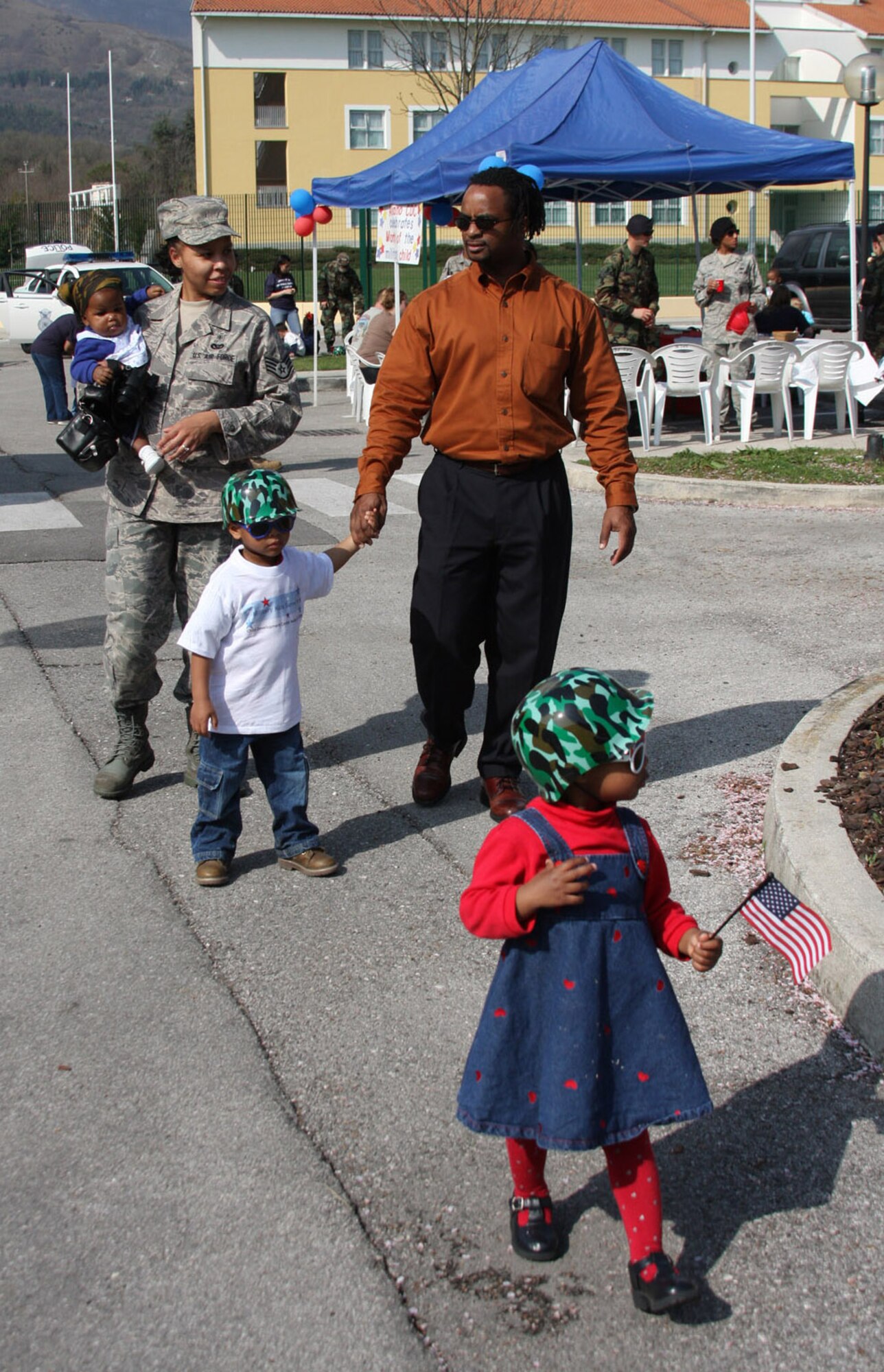 Staff Sgt. Lakiesha and Walter Foggie and their children (from left to right) Joselyn, Caleb and Gabby participate in the Area 1 Child Development Center's Annual Month of the Military Child Parade earlier this month. The Department of Defense observance, now in its 23rd year, reflects on the important role military children play in the Armed Forces community. (U.S. Air Force photo/Rebecca White)

