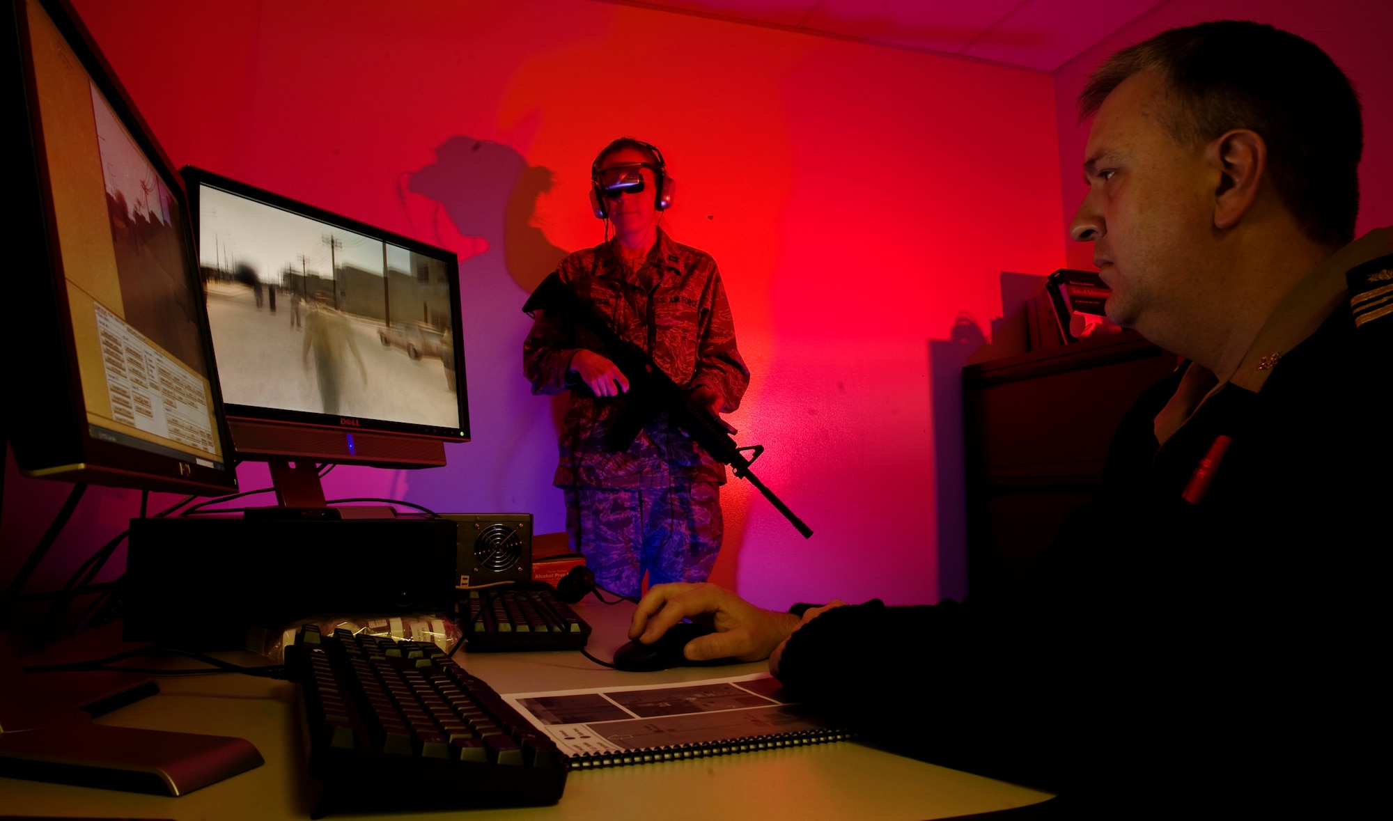 Captain Heather Bautista (standing) and Lieutenant Commander William Satterfield, checks the operation of a virtual reality software for returning veterans with combat post traumatic stress disorder at the David Grant USAF Medical Center at Travis Air Force Base, Calif., April 17. Capt. Bautista, U.S. Air Force and LCDR. Satterfield, U.S. Public Health Service are assigned to the center's mental health clinic. (U.S. Air Force photo/Lance Cheung)
