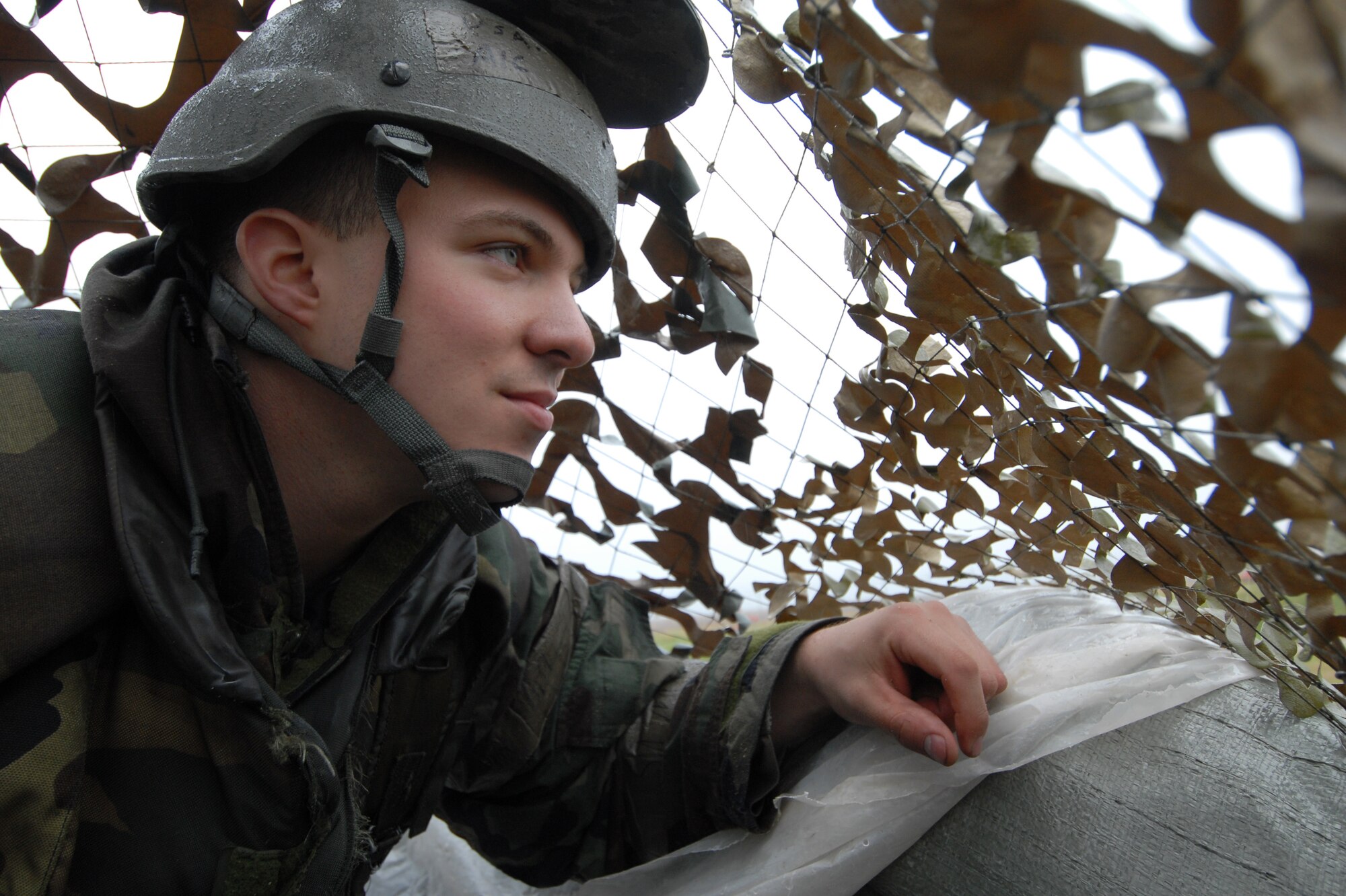 Airman 1st Class Allen Green scans for enemy forces and other threats during the Operational Readiness Inspection at Kunsan Air Base, Republic of Korea, April 20, 2009. Airman Green is a security forces augmentee assigned to the 8th Logistic Readiness Squadron. (U.S. Air Force Photo/Senior Airman Gustavo Gonzalez)