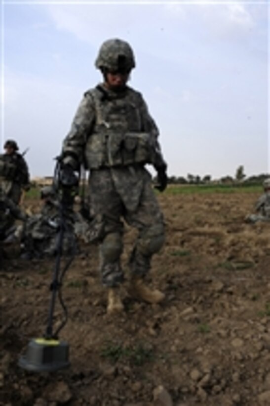 U.S. Army Spc. Amato from 1st Battalion, 6th Infantry Regiment, 2nd Brigade Combat Team, 1st Armored Division uses a metal detector to scan the area in Owesat, Iraq, on April 12, 2009.  