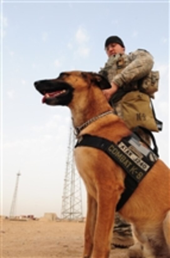 U.S. Air Force Joel Townsend assigned to 1st Cavalry Division and his dog, Atak, prepare to search for weapons caches in Qarghul, Iraq, on April 13, 2009.  