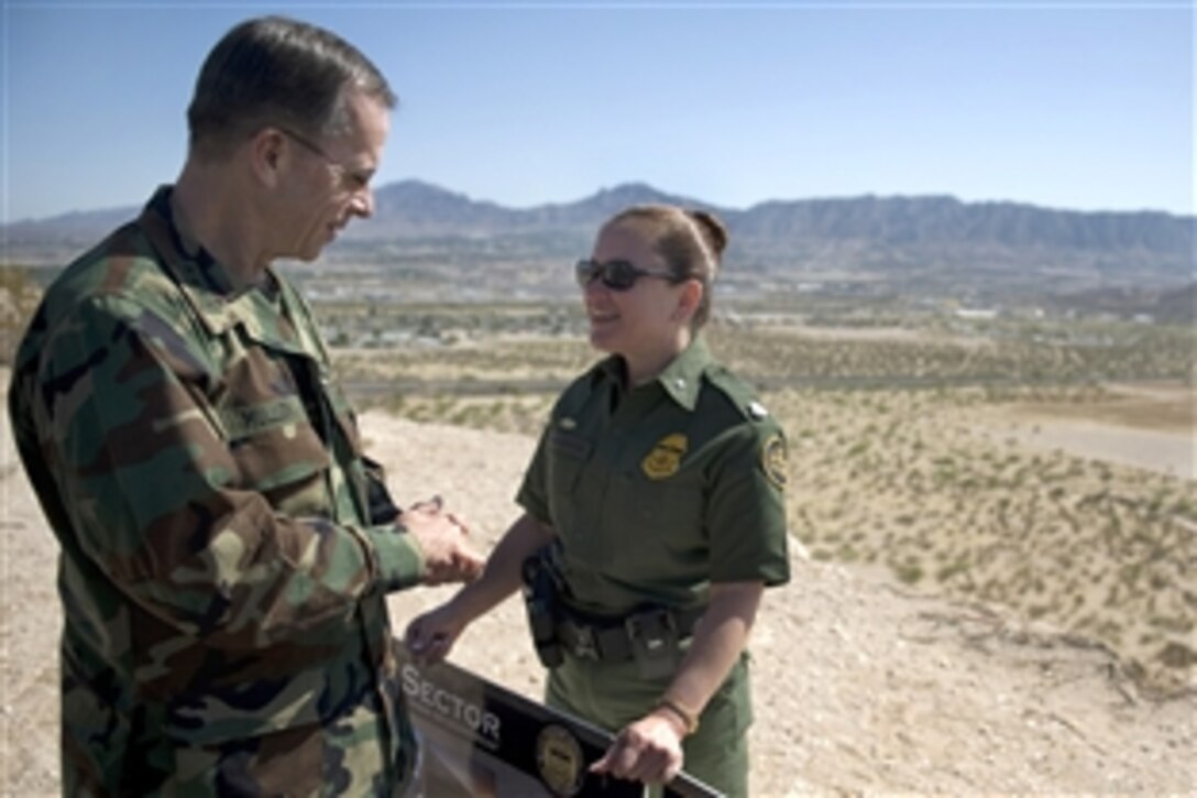 U.S. Navy Adm. Mike Mullen, chairman of the Joint Chiefs of Staff, speaks with Maria Valencia, a U.S. Border Patrol agent, at a stop to observe the U.S. - Mexican border while in El Paso, Texas, April 17, 2009. Mullen also visited Joint Task Force-North to better understand the current situation and violence that is plaguing the region.