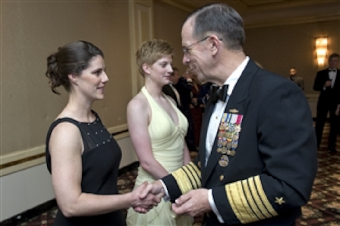 U.S. Navy Adm. Mike Mullen, chairman of the Joint Chiefs of Staff, congratulates two new U.S. Coast Guard enlistees after they took their oath before the Dallas Military Ball, April 18, 2009. Mullen was the guest of honor at the 45th annual event dedicated to honoring active and retired military in the greater Dallas-Fort Worth metropolitan community. 