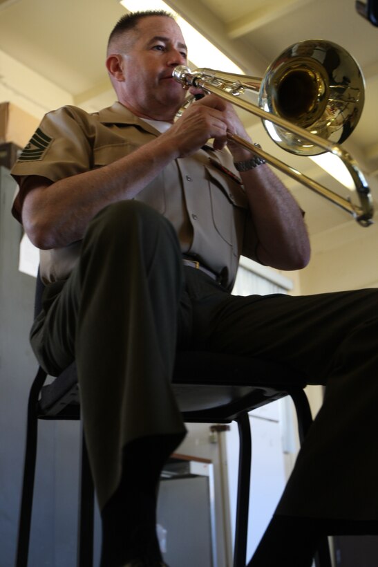Master Sgt. Charles Casey, a trombone player with “The President’s Own” United States Marine Band, makes his instrument sing as he mentors the trombone players in the Combat Center band April 21.