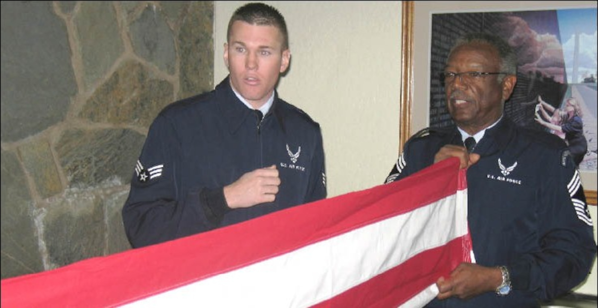 Senior Airman Kyle Platt, March ARB Honor Guard, coaches CMSgt. Hosea Taylor, USAF (Ret.) and a member of Team 38 of the Riverside National Cemetery Memorial Honor Detail on the finer points of flag folding during a recent training session at the cemetery. The MHD is comprised of 500 volunteers who augment active duty, Guard  and Reserve honor guards in providing military honors for veterans burial services at Riverside National Cemetery about 6,500 times each year. (U.S. Air Force photo courtesy of Riverside National Cemetery)