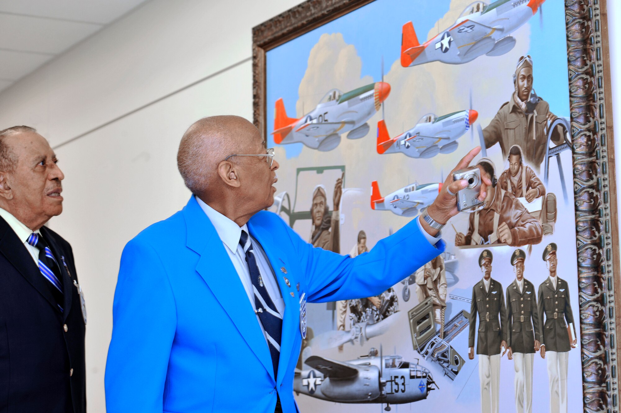 At the Pentagon April 20, Tuskegee Airmen Alexander Jefferson (right)  and James Warren admire artwork depicting fellow Tuskegee Airmen. Four Tuskegee Airmen and retired Lt. Gen. Russell Davis were in Washington to meet with Air Force Chief of Staff Gen. Norton Schwartz and Vice Chief Gen. William Fraser III en route to visit Airmen deployed to several countries in the U.S. Central Command area of responsibility. The Airmen will visit the 332nd Air Expeditionary Wing whose origins trace back to the 332nd Fighter Group and the Tuskegee Red Tail Flyers.  (U.S. Air Force photo/Scott M. Ash)