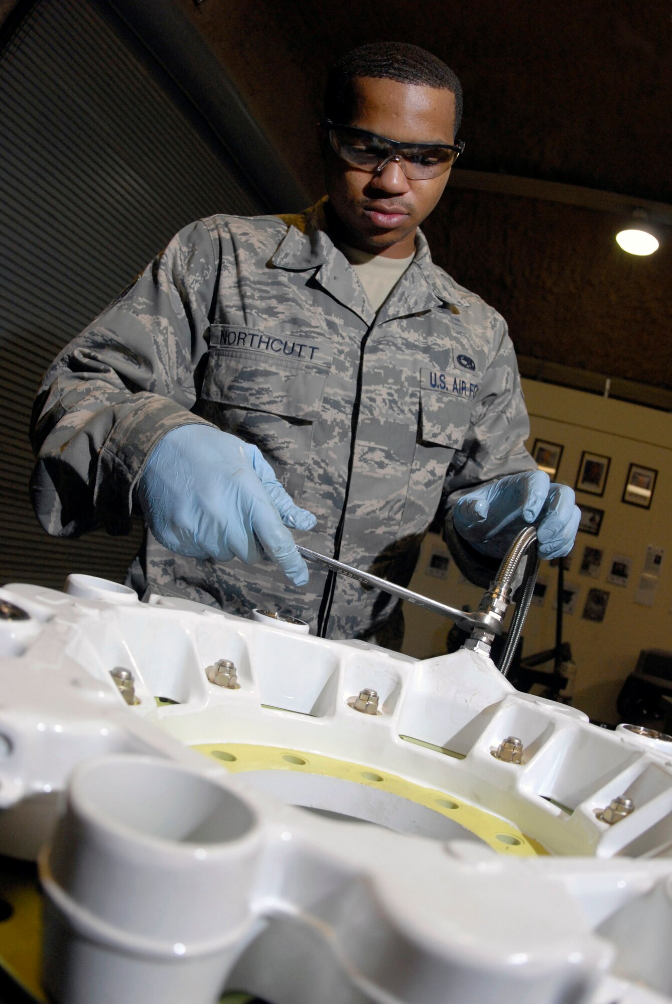 Senior Airman Joseph Northcutt attaches a hydraulic test hose to check a KC-135 Stratotanker steel brake unit for leaks April 17 at an air base in Southwest Asia.  The base hydraulic shop supports all of the C-135 airframes in the U.S. Central Command's area of responsibility.  Airman Northcutt is a hydraulics journeyman with the 379th Expeditionary Maintenance Squadron, and is deployed from Fairchild Air Force Base, Wash., in support of Operations Iraqi and Enduring Freedom and Combined Joint Task Force - Horn of Africa.  (U.S. Air Force photo/Senior Airman Andrew Satran) 