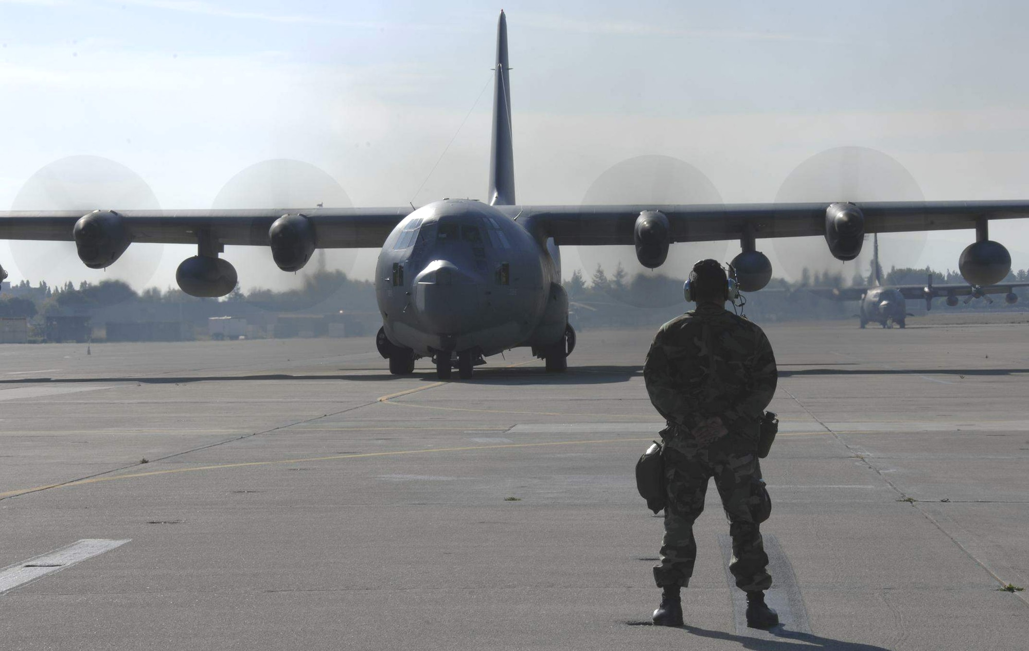 Two MC-130P Combat Shadow tanker aircraft from the 129th Rescue Wing at Moffett Federal Airfield, Calif., taxi on the Moffett flightline.  (U.S. Air Force photo)