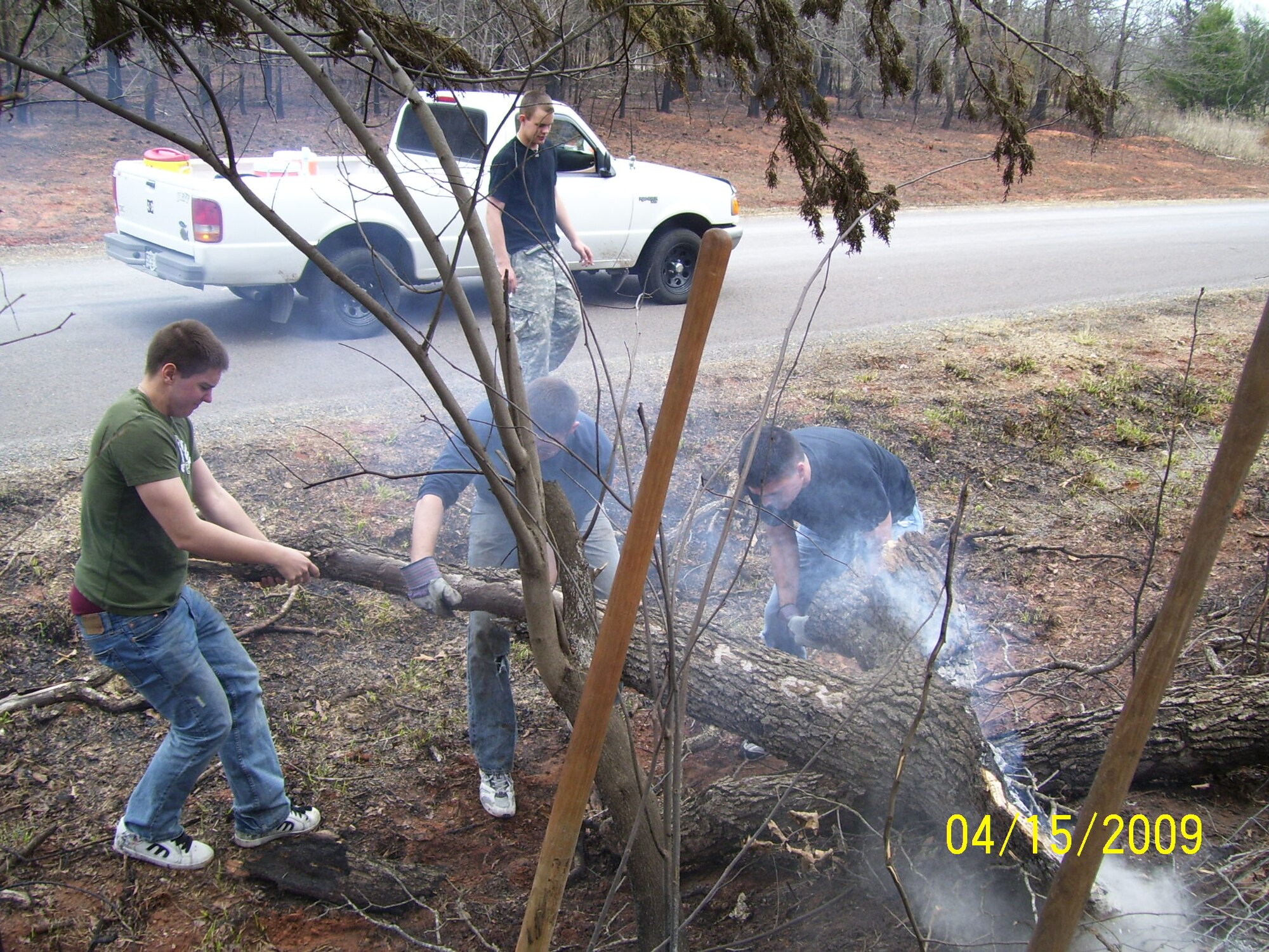 Airmen from the 552nd Training Squadron helped prevent another outbreak of fires by extinguishing a log  on the side of the road that had been engulfed by flames.