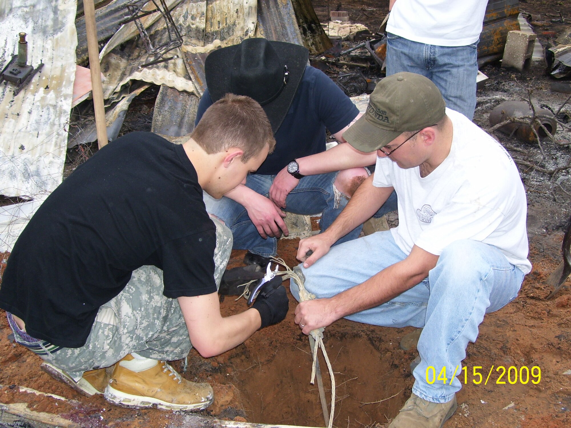 Airmen from the 552nd Training Squadron help clean up after a wildfire destroyed a local family's home.