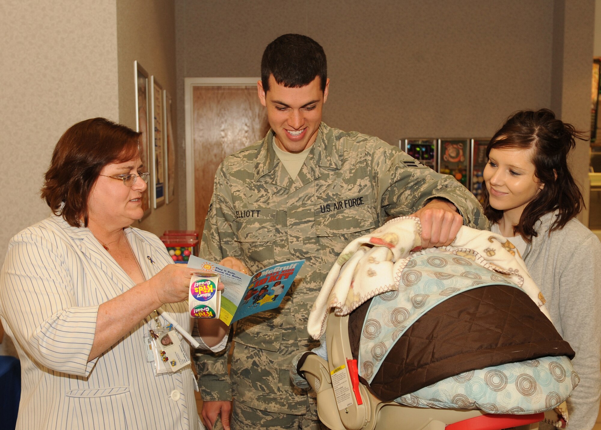 DYESS AIR FORCE BASE Texas - Diane Bradley, Family Advocacy Program Assistant, informs Airman 1st Class Robert Elliott, from the 317th Operation Support Squadron, and his wife Pascale about classes offered for first time parents here, April 17. April is Month of the Military Child. (U.S. Air Force photo by Senior Airman Felicia Juenke)