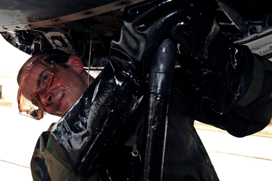 Airman 1st Class Derrick Gregg, 28th Maintenance Squadron crew chief, removes a hydraulic test line from a B-1B Lancer on the flight line, April 17. The B-1 is a long-range bomber capable of delivering massive quantities of precision and non-precision weapons against any adversary, anywhere in the world, at any time. (U.S. Air Force photo/Senior Airman Marc I. Lane)