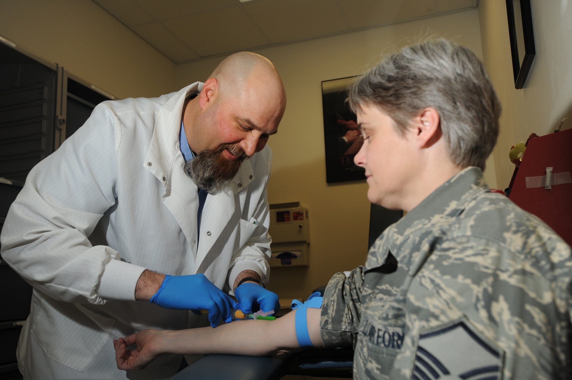 ELMENDORF AIR FORCE BASE, Alaska-- Mike Bush of 3 Medical Support Squadron (3MDSS) gives Master Sgt. Susan Andersen, also from 3 MDSS, a blood test April 15, 2009. Blood tests are used for an abundance of purposes and are very critical to our health. (U.S. Air Force photo by Airman First Class Kristin High)